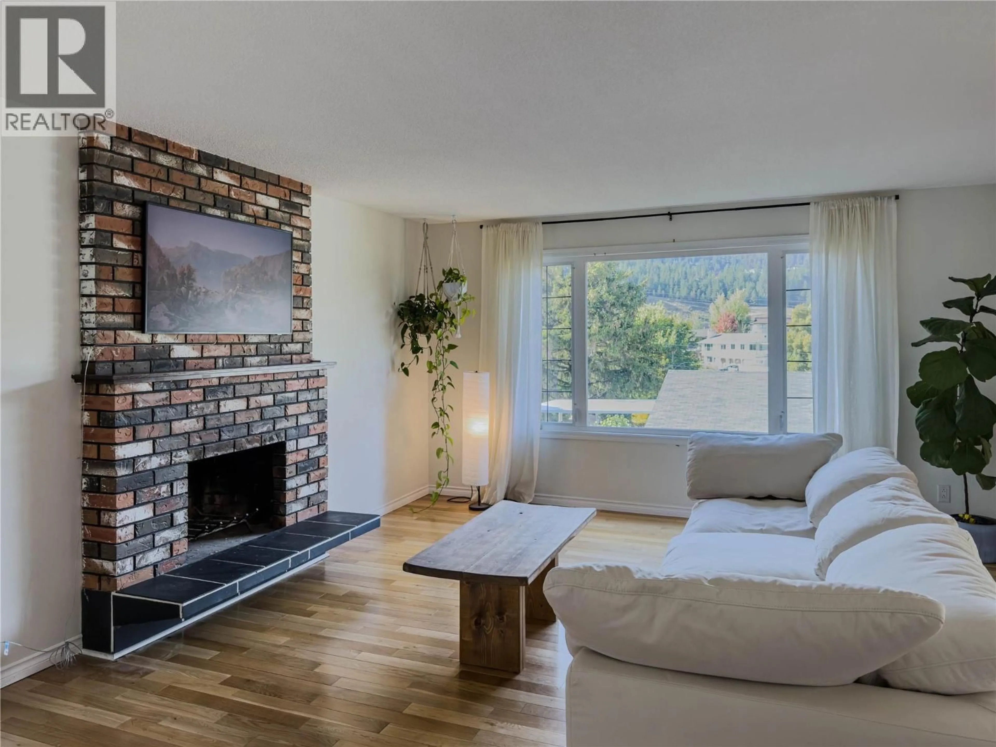 Living room with furniture, wood/laminate floor for 1595 MT DUFFERIN AVENUE, Kamloops British Columbia V2E1A8