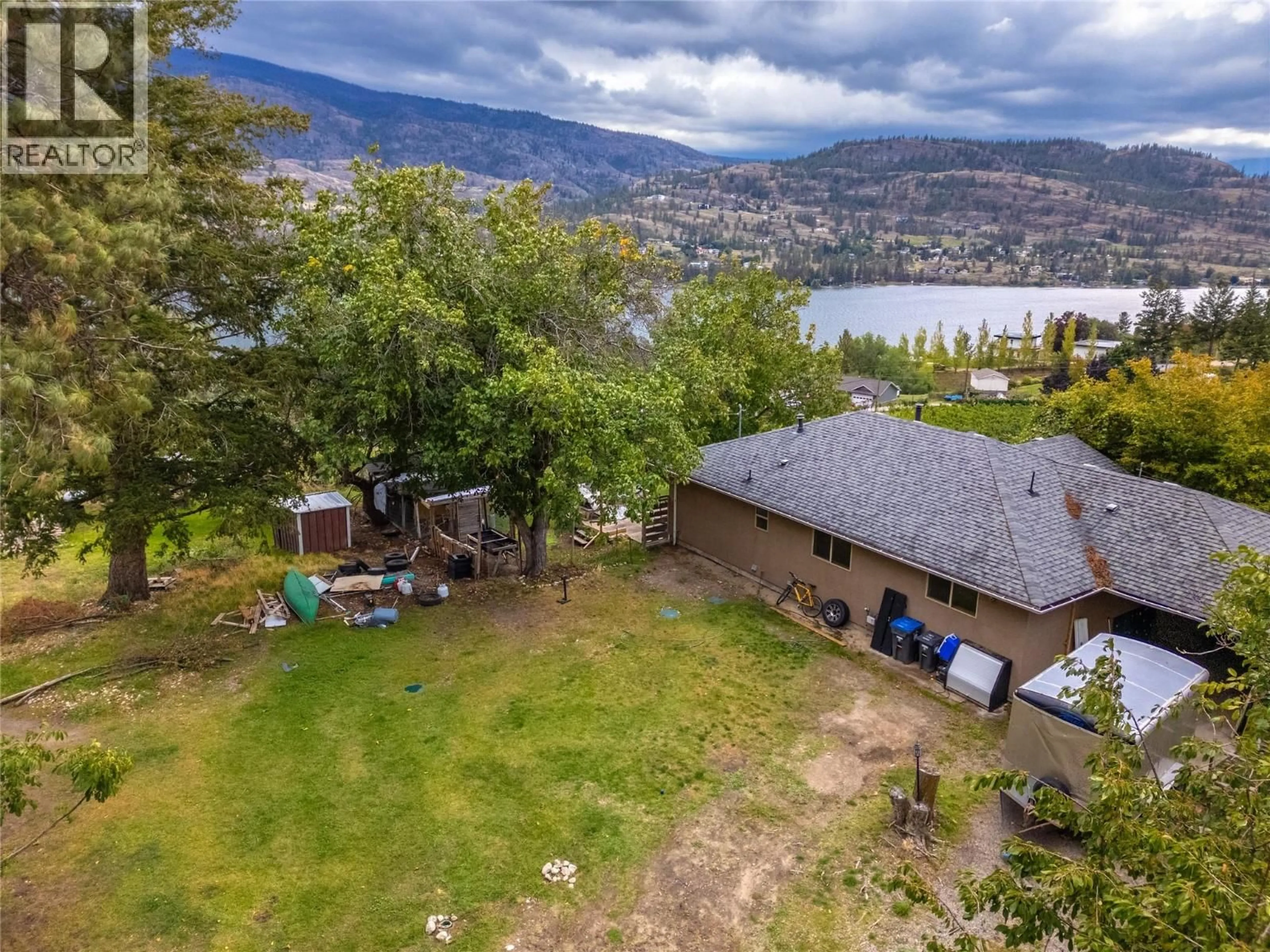 A pic from outside/outdoor area/front of a property/back of a property/a pic from drone, water/lake/river/ocean view for 213 TAMARAC AVENUE, Kaleden British Columbia V0H1K0