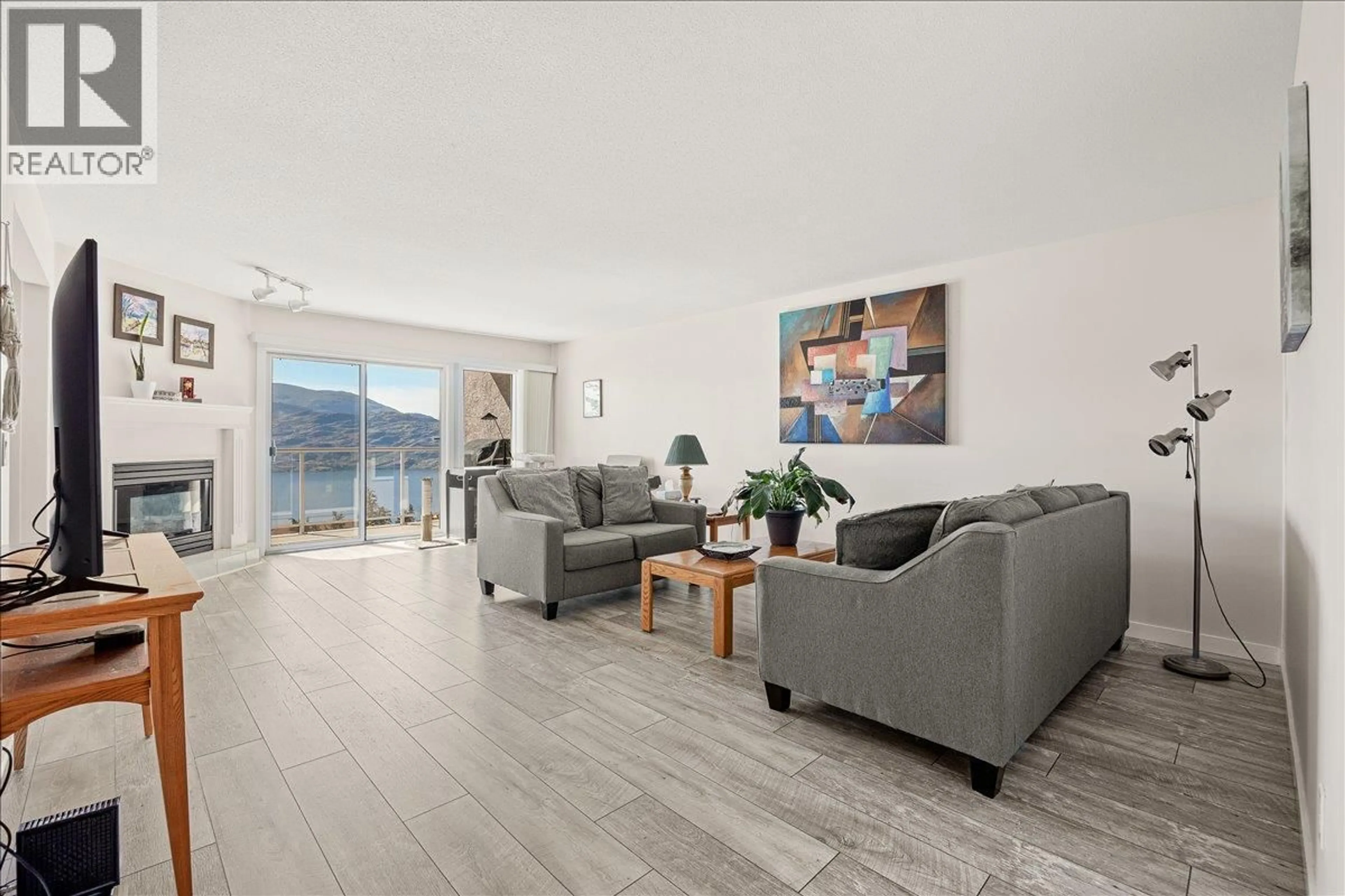 Living room with furniture, wood/laminate floor for 106 - 4630A PONDEROSA DRIVE, Peachland British Columbia V0H1X5