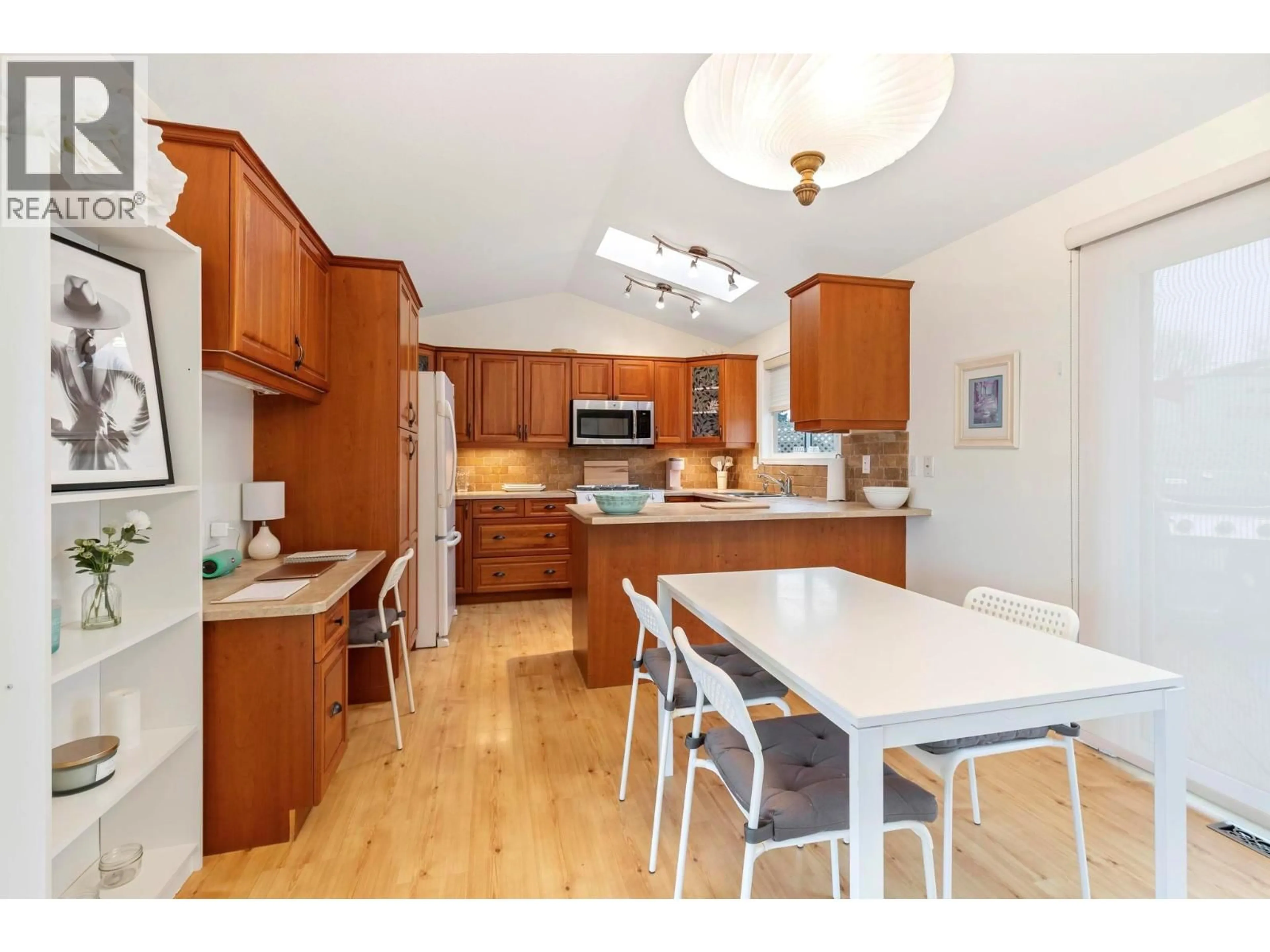 Open concept kitchen, wood/laminate floor for 25 - 415 COMMONWEALTH ROAD, Kelowna British Columbia V4V1P4