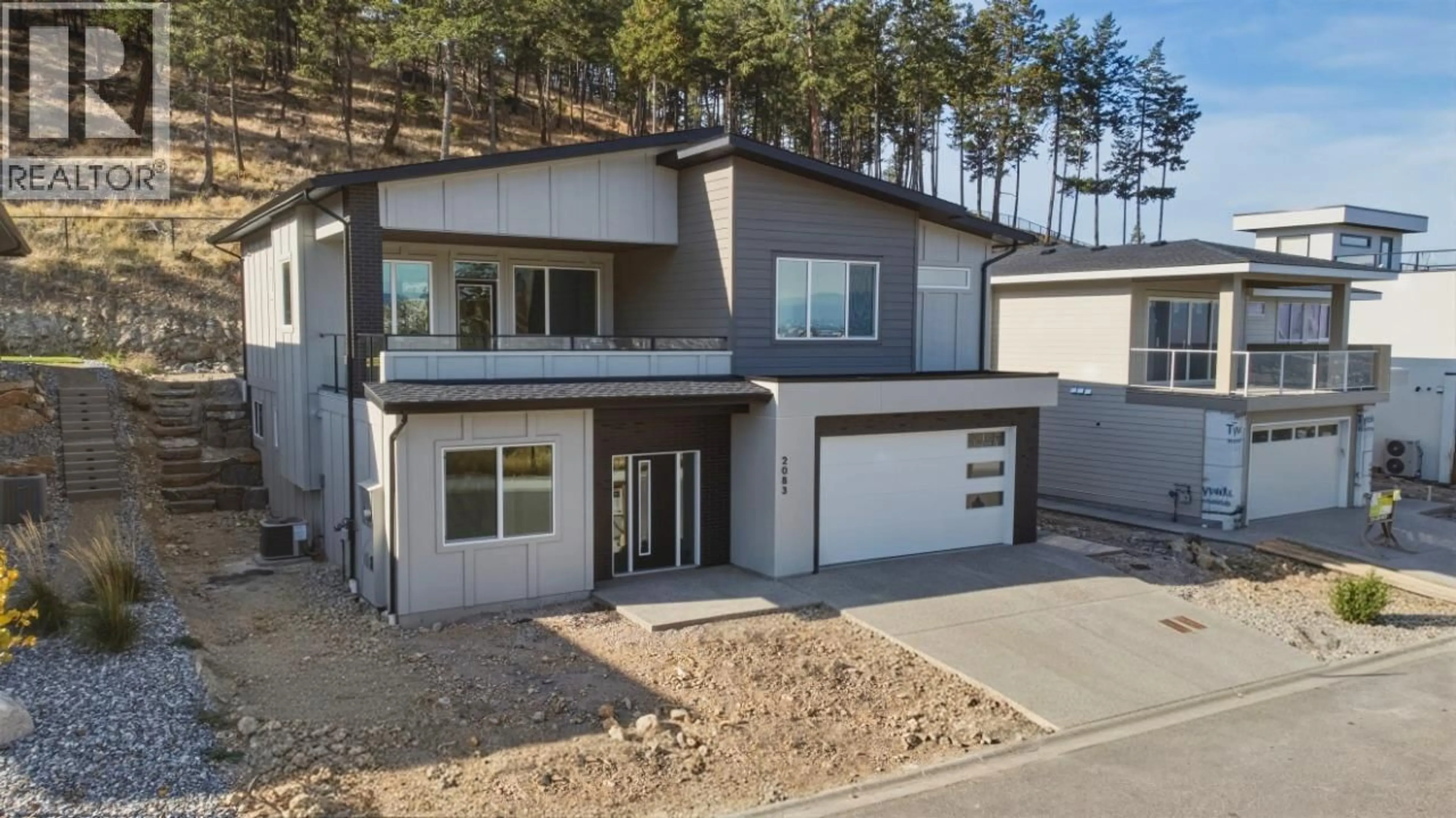 Home with vinyl exterior material, street for 2083 CORTINA DRIVE, Kelowna British Columbia V1P1V1