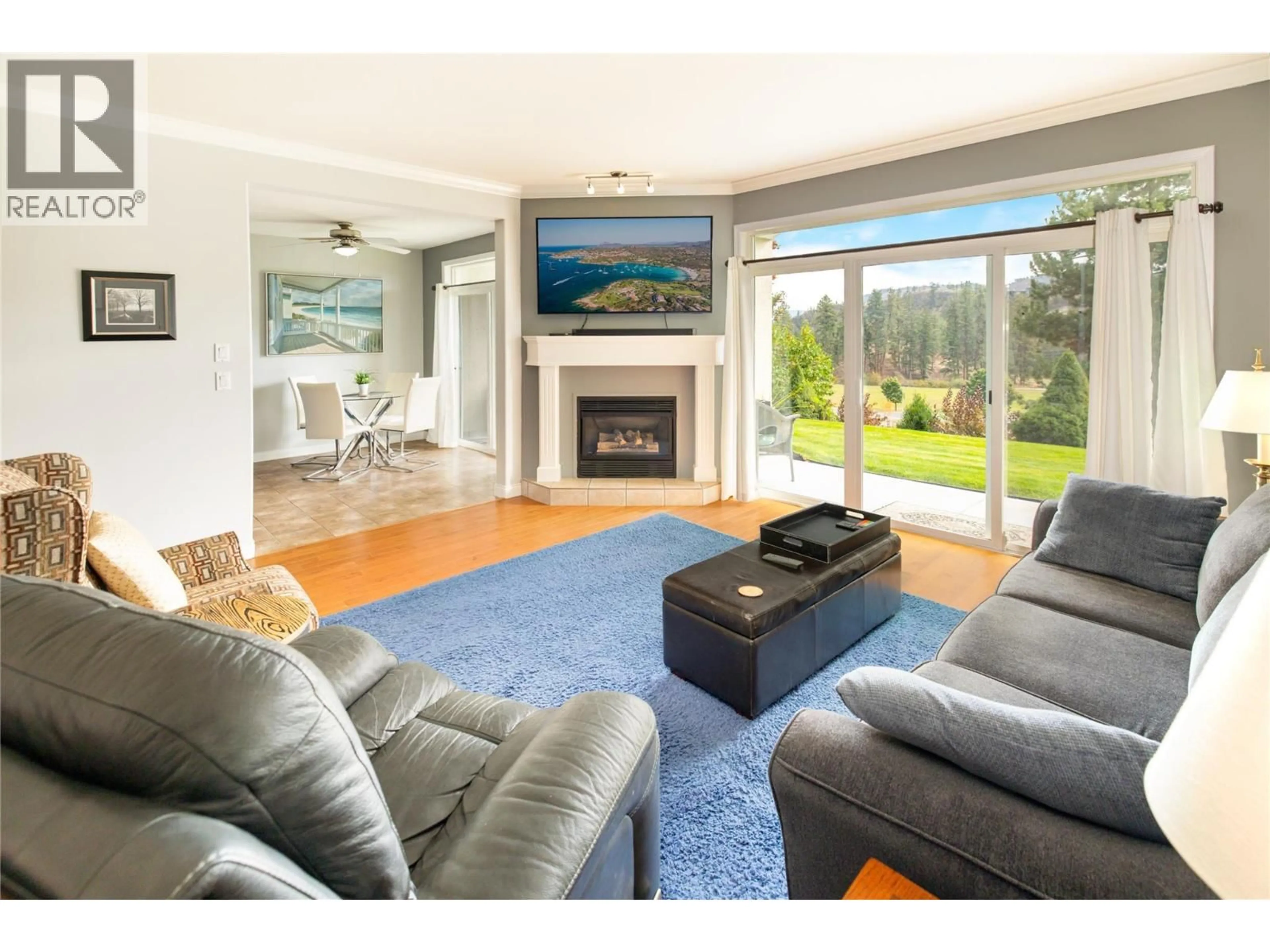 Living room with furniture, wood/laminate floor for 104 - 2377 SHANNON WOODS DRIVE, West Kelowna British Columbia V4T2L8