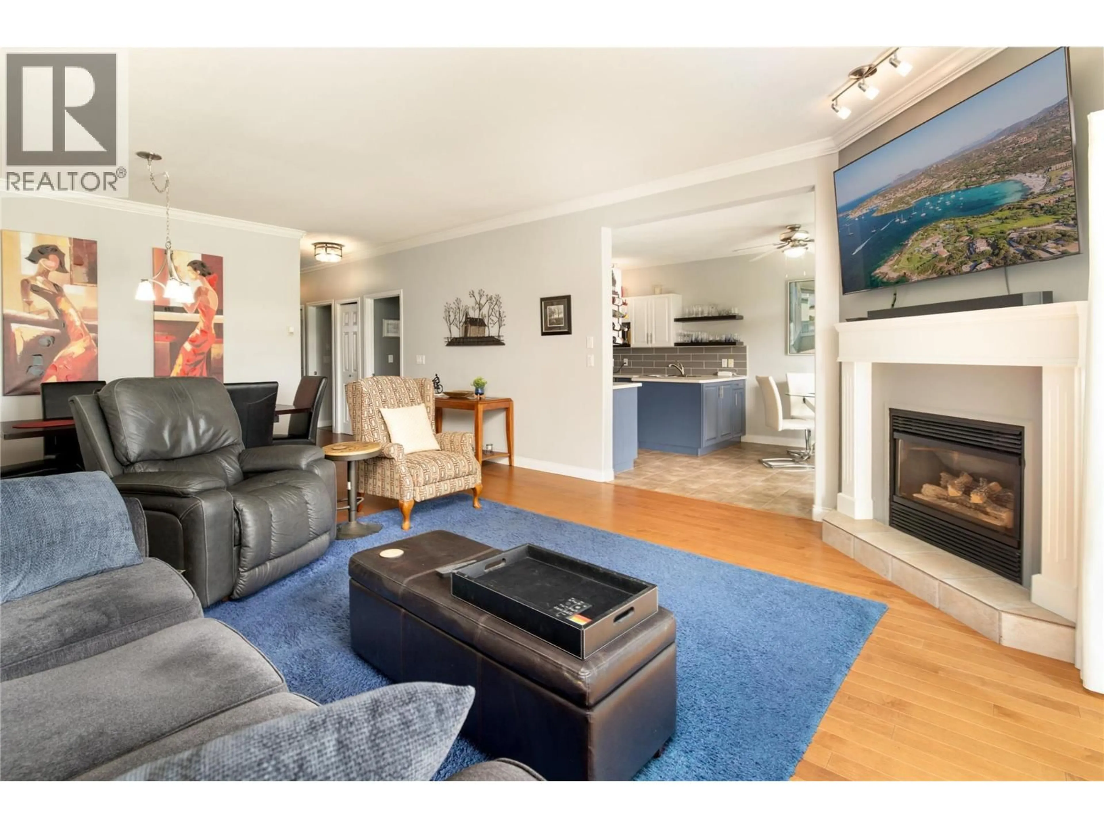 Living room with furniture, wood/laminate floor for 104 - 2377 SHANNON WOODS DRIVE, West Kelowna British Columbia V4T2L8