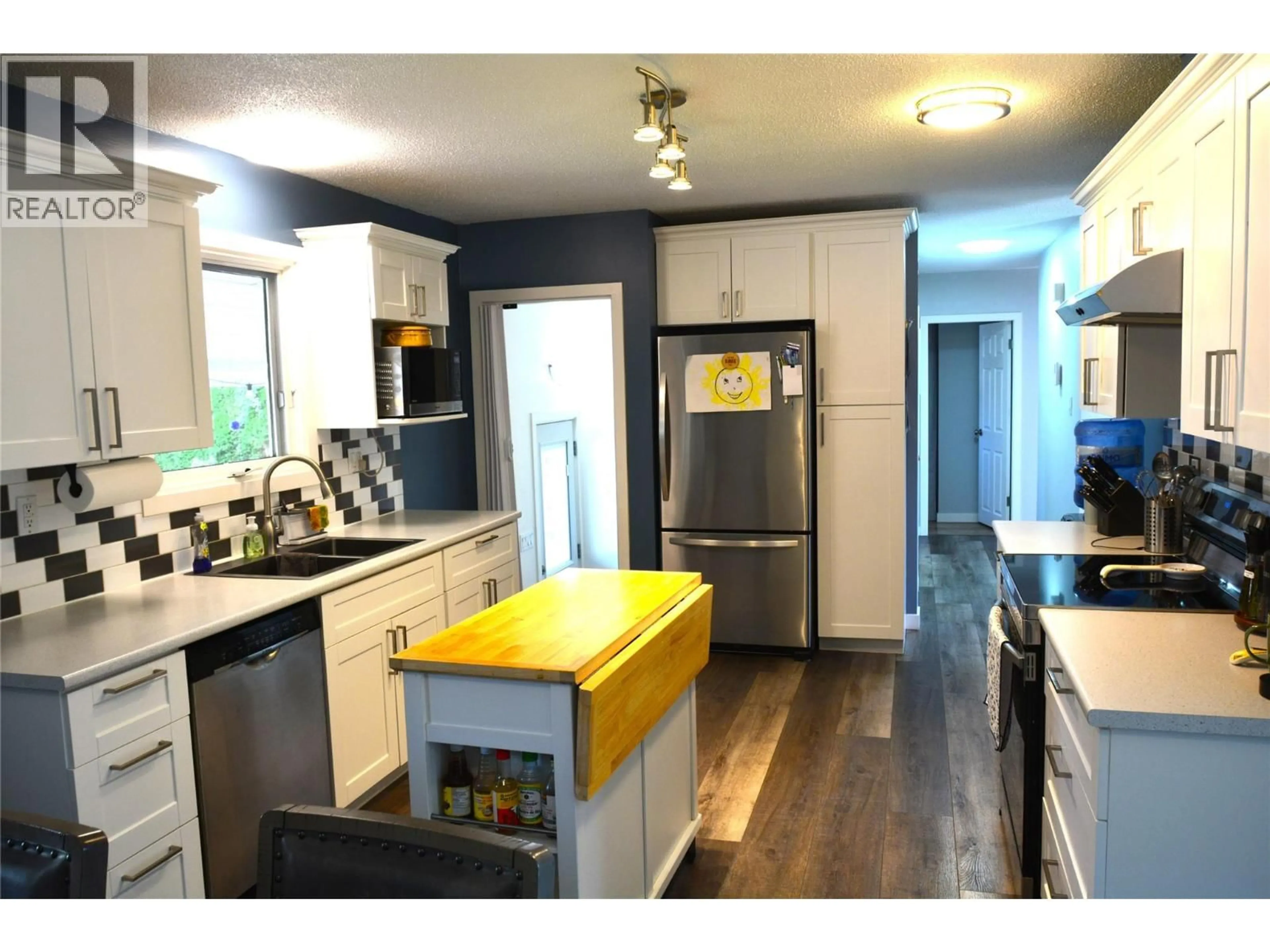 Open concept kitchen, wood/laminate floor for 2236 GREENFIELD AVENUE, Kamloops British Columbia V2B4P3