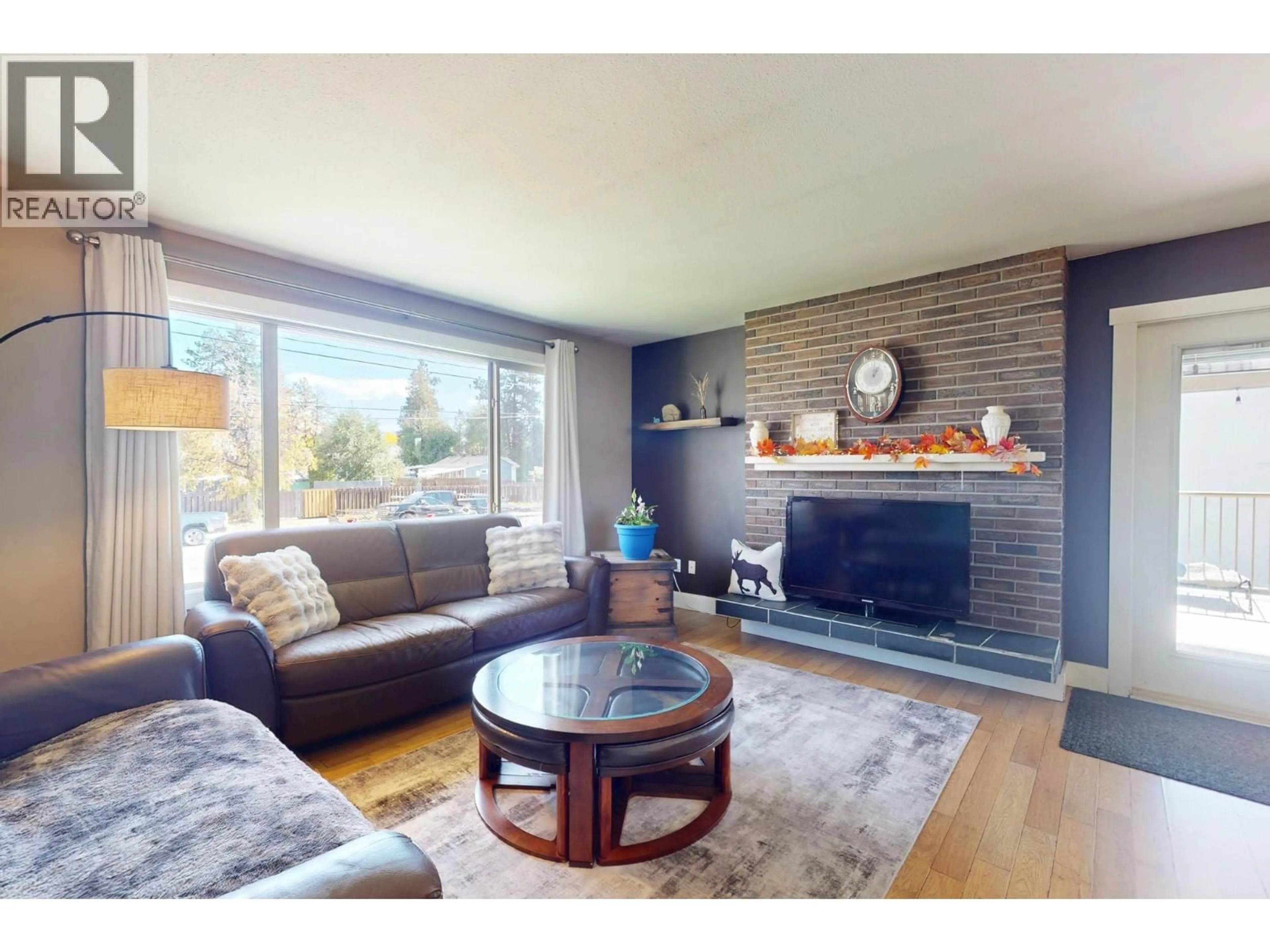 Living room with furniture, wood/laminate floor for 620 ZIPRICK ROAD, Kelowna British Columbia V1X5R5