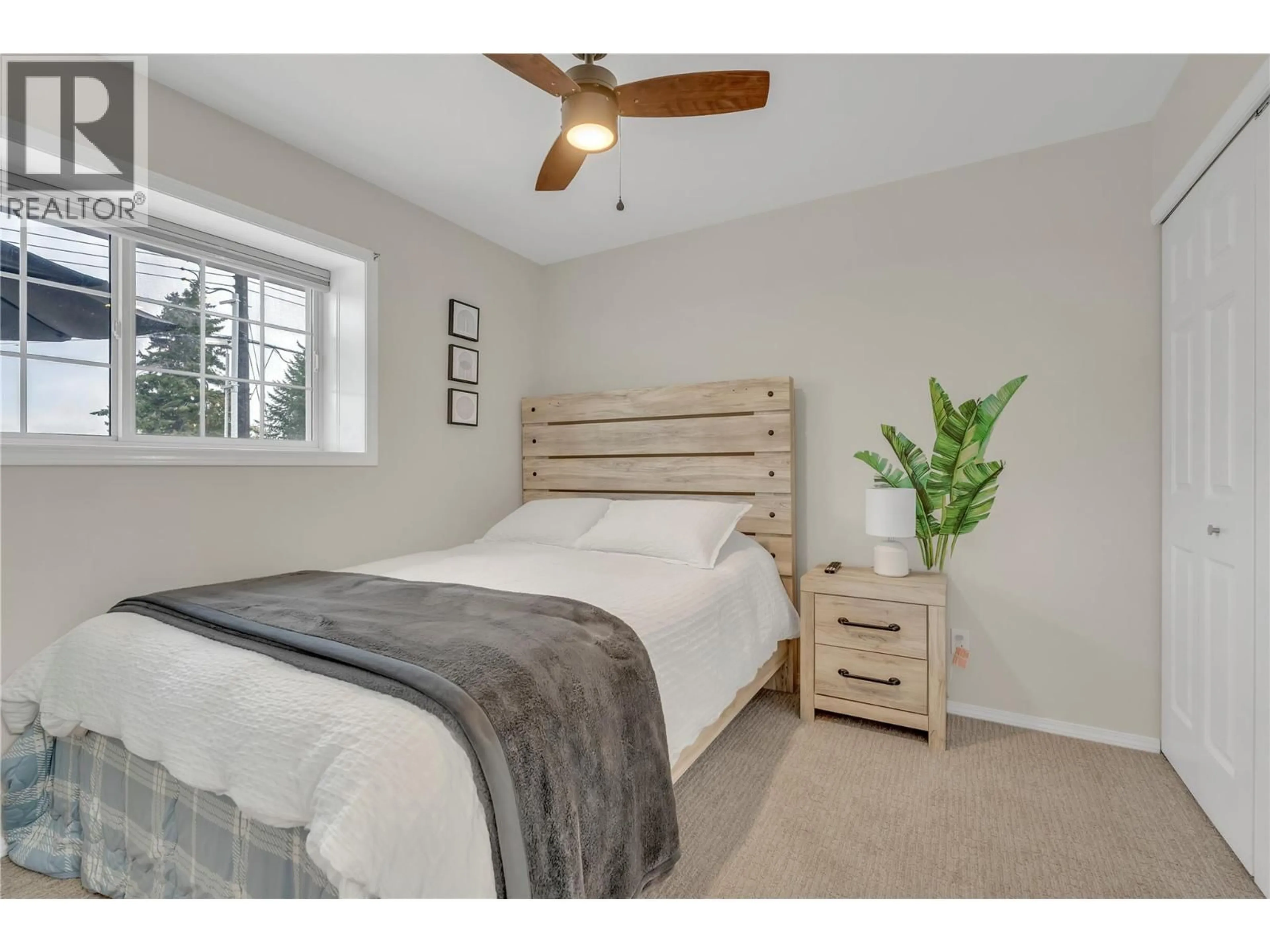 Bedroom with bed, wood/laminate floor for 114 VANCOUVER PLACE, Penticton British Columbia V2A1A7