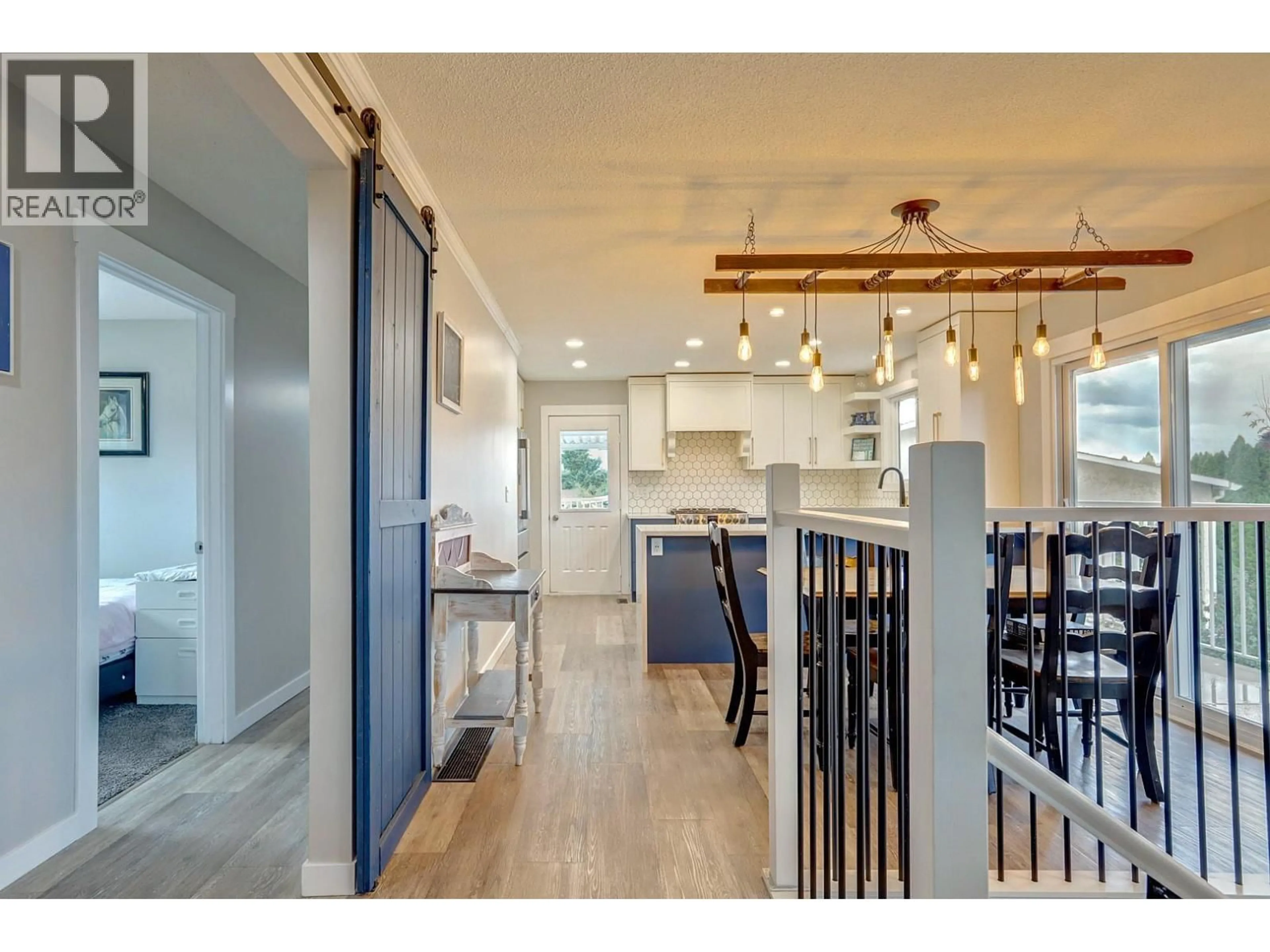Open concept kitchen, wood/laminate floor for 5723 RICHARDS CRESCENT, Vernon British Columbia V1B3R1
