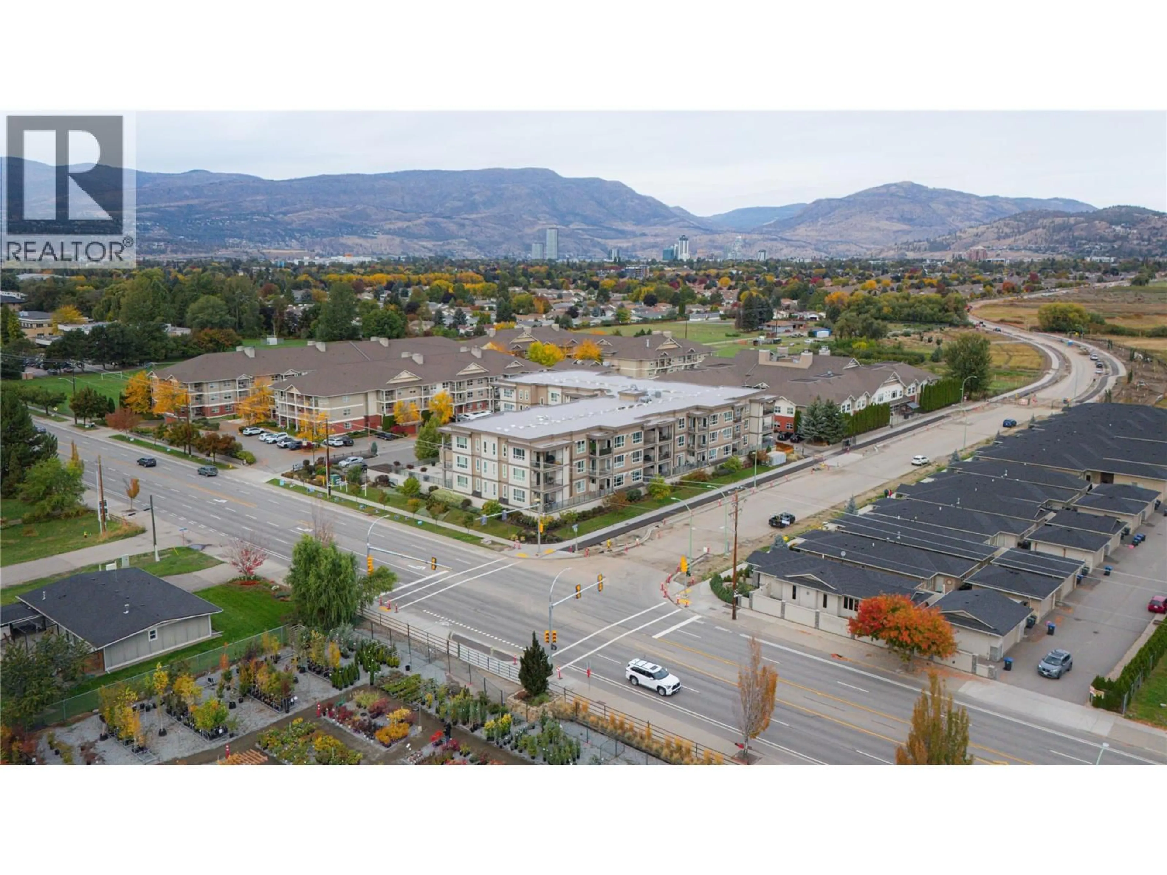 A pic from outside/outdoor area/front of a property/back of a property/a pic from drone, mountain view for 103 - 3090 BURTCH ROAD, Kelowna British Columbia V1W5G9