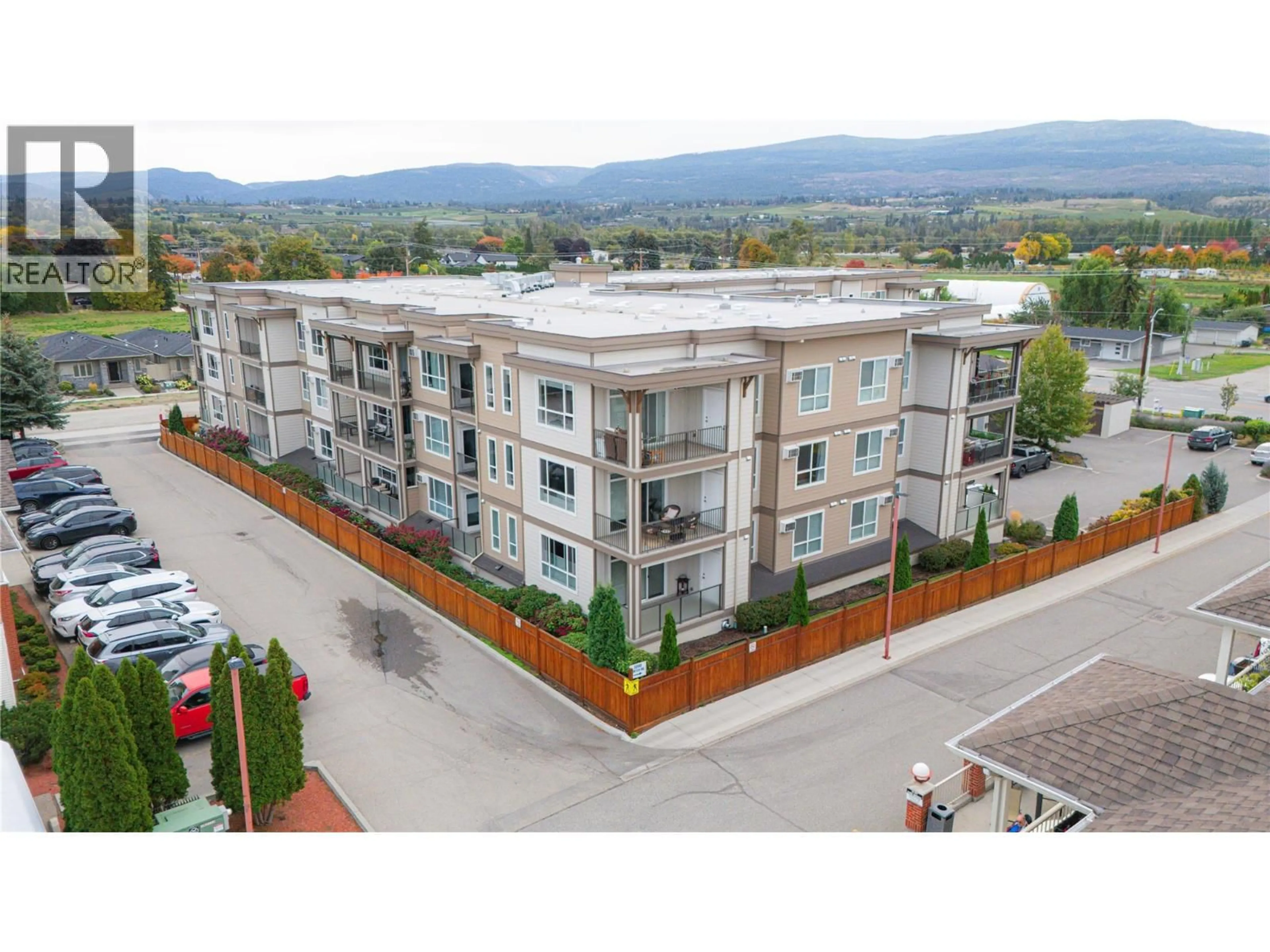 A pic from outside/outdoor area/front of a property/back of a property/a pic from drone, mountain view for 103 - 3090 BURTCH ROAD, Kelowna British Columbia V1W5G9