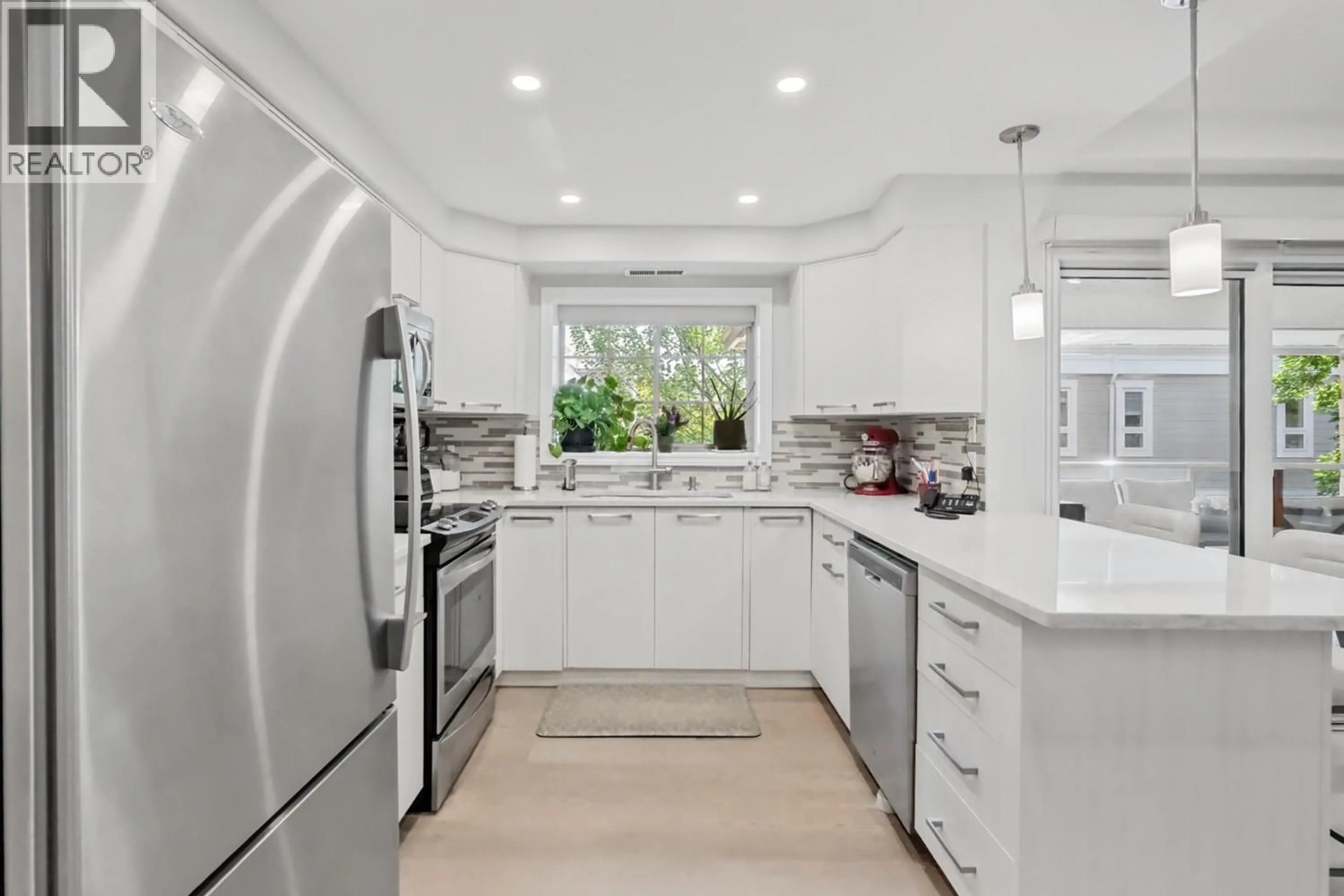 Contemporary kitchen, ceramic/tile floor for 201 - 3335 RICHTER STREET, Kelowna British Columbia V1W3Y1