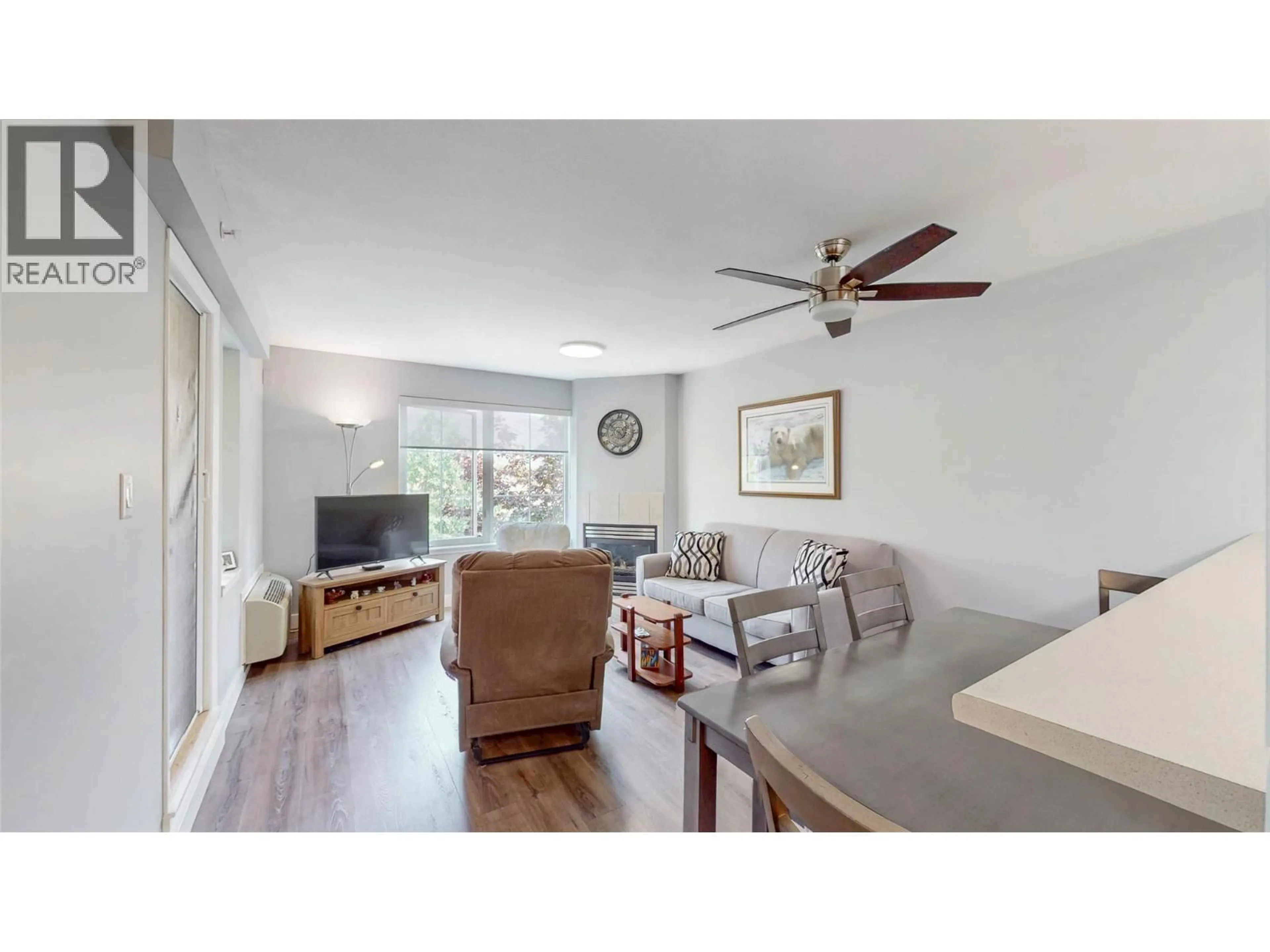 Living room with furniture, wood/laminate floor for 308 - 7600 COTTONWOOD DRIVE, Osoyoos British Columbia V0H1V3