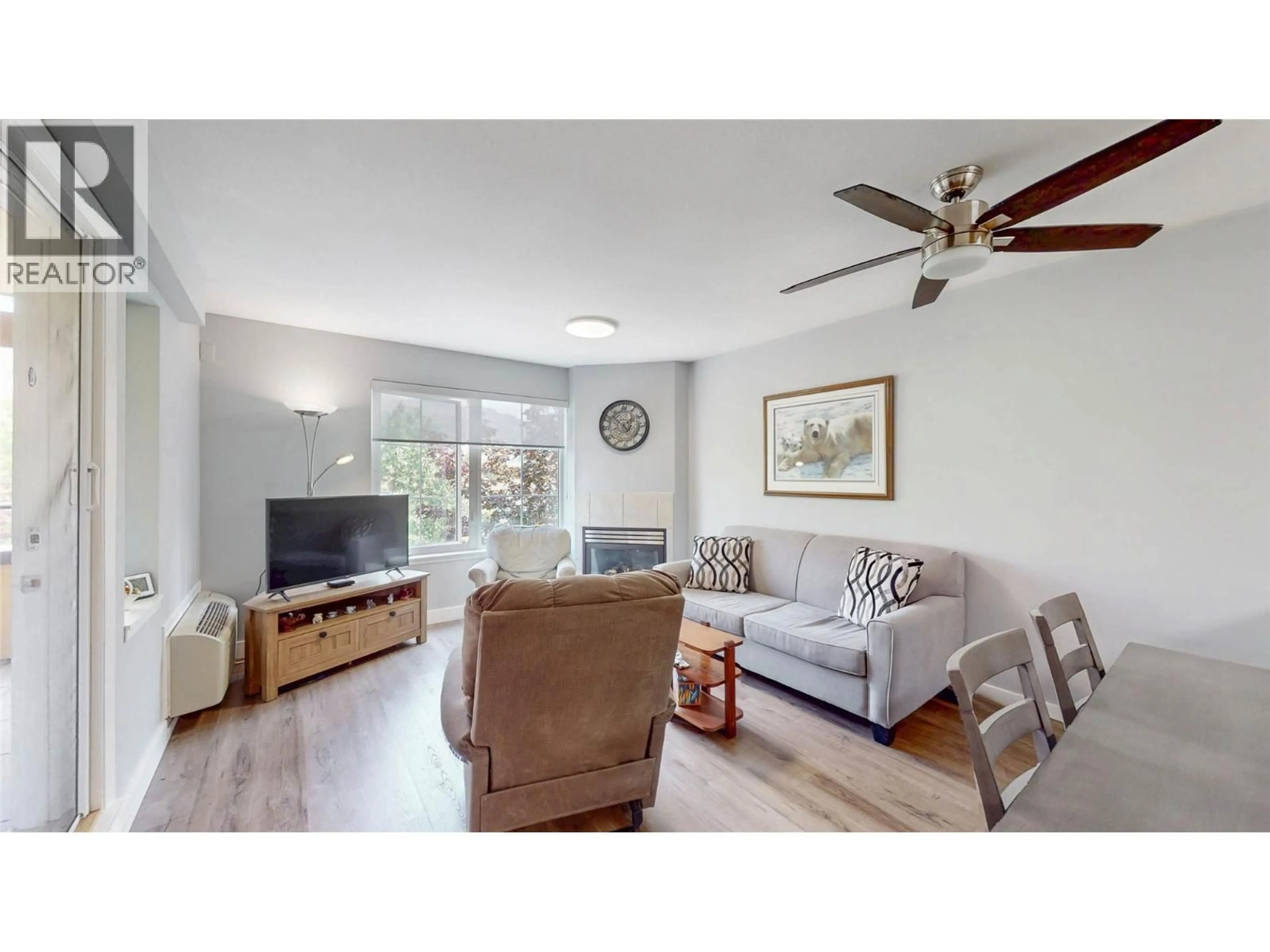 Living room with furniture, wood/laminate floor for 308 - 7600 COTTONWOOD DRIVE, Osoyoos British Columbia V0H1V3