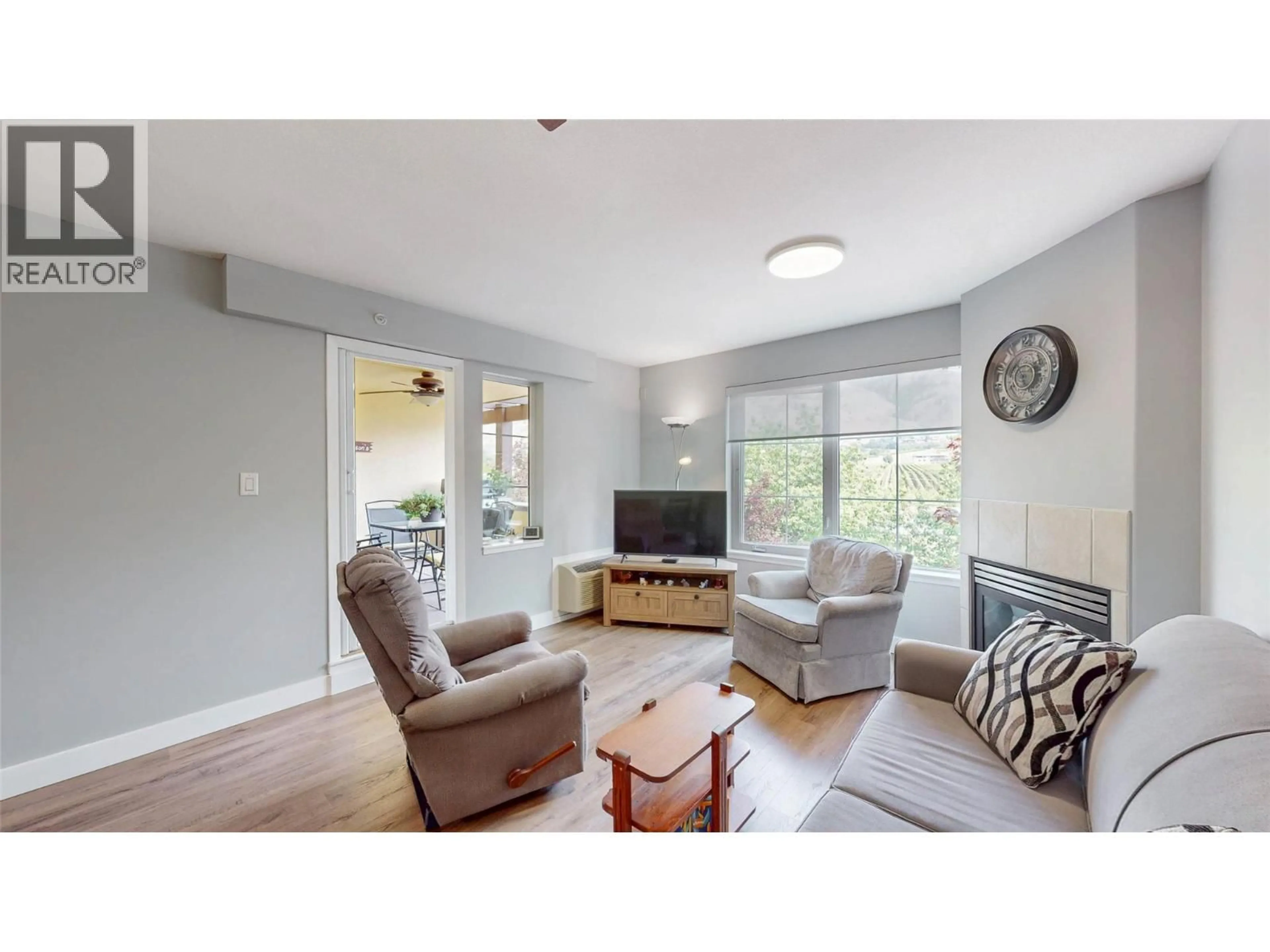 Living room with furniture, wood/laminate floor for 308 - 7600 COTTONWOOD DRIVE, Osoyoos British Columbia V0H1V3