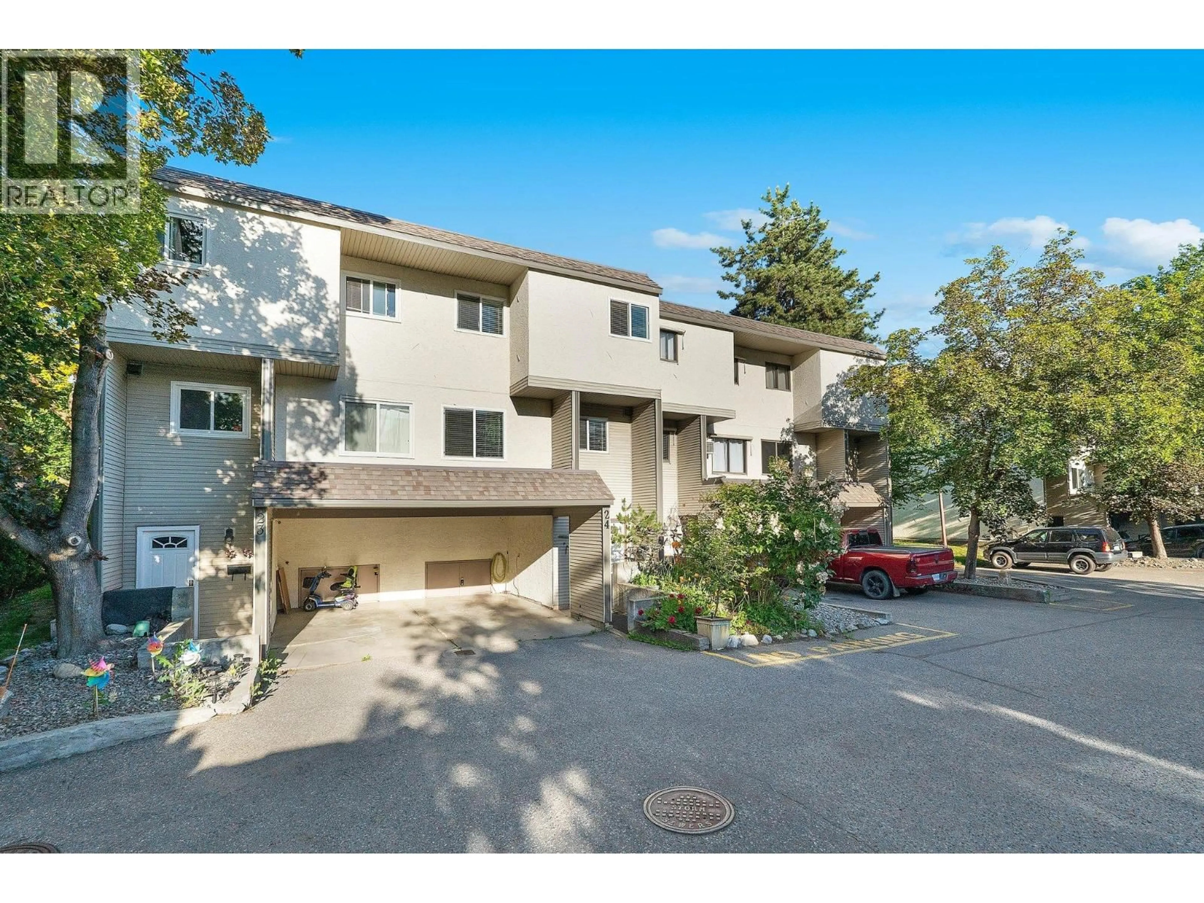 A pic from outside/outdoor area/front of a property/back of a property/a pic from drone, street for 24 - 1985 BURTCH ROAD, Kelowna British Columbia V1Y4B4