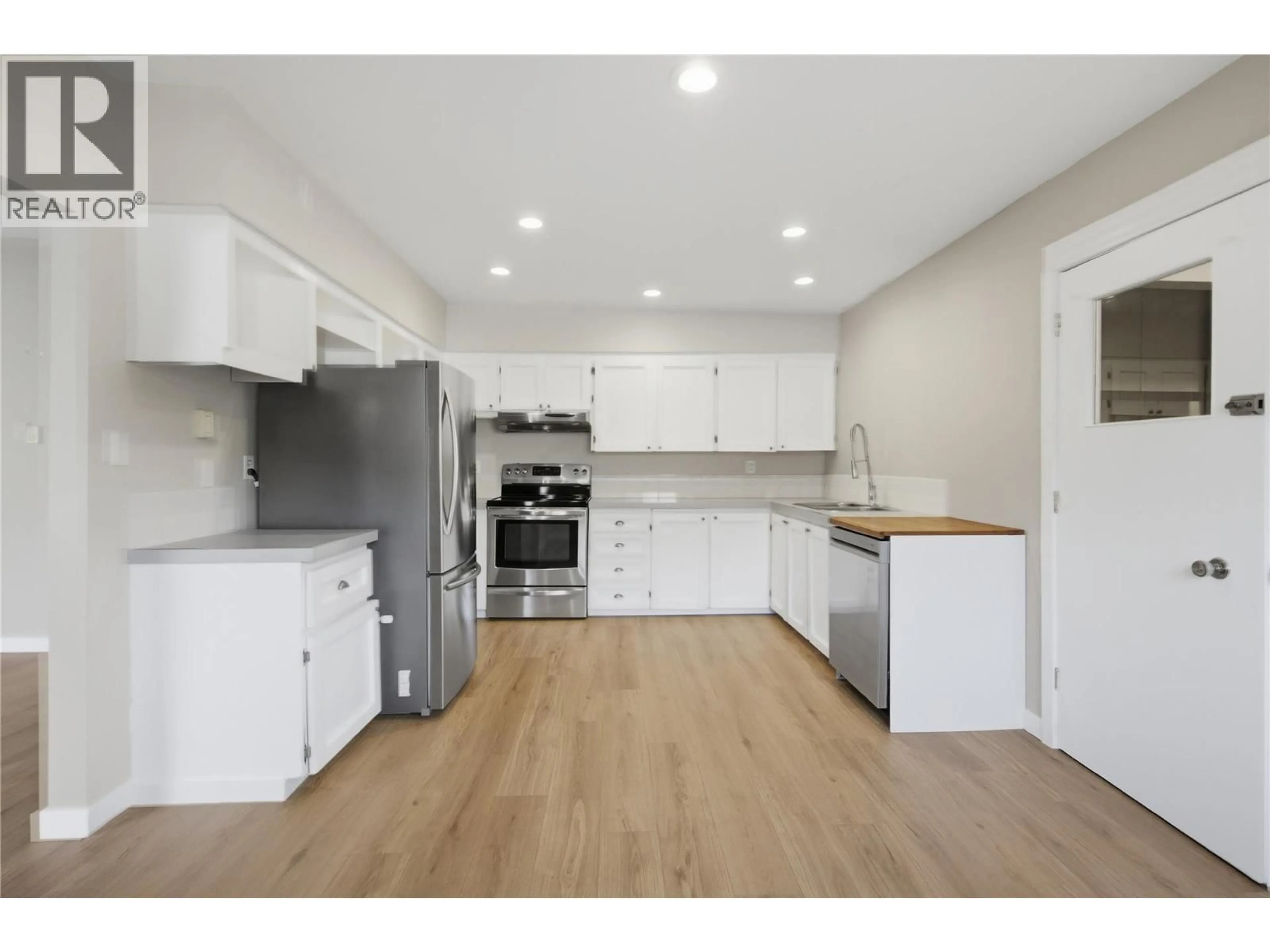 Open concept kitchen, wood/laminate floor for 2231/2233 VALLEYVIEW DRIVE, Kamloops British Columbia V2C4C8