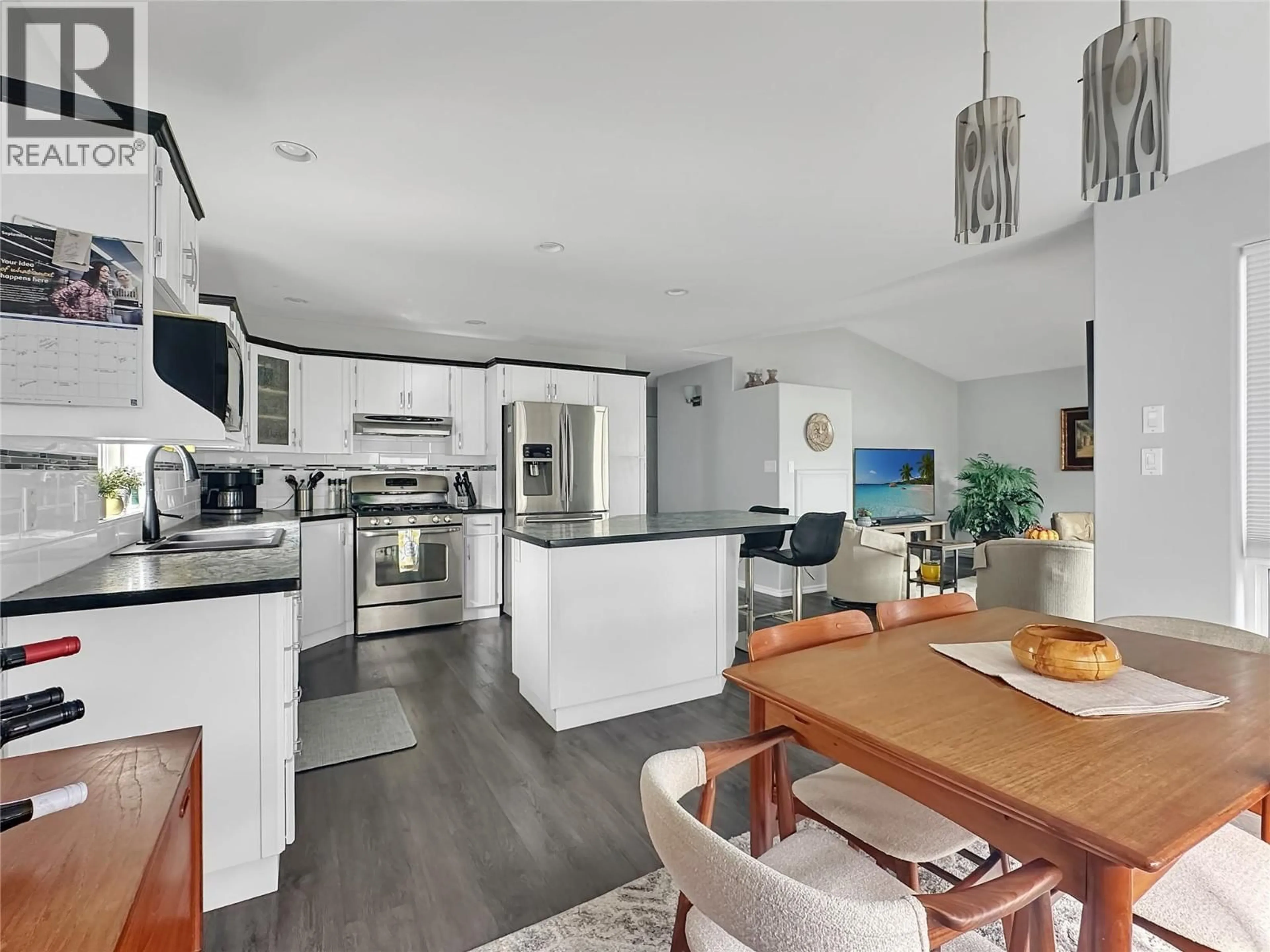 Open concept kitchen, wood/laminate floor for 40 - 6526 TUCELNUIT DRIVE, Oliver British Columbia V0H1T3