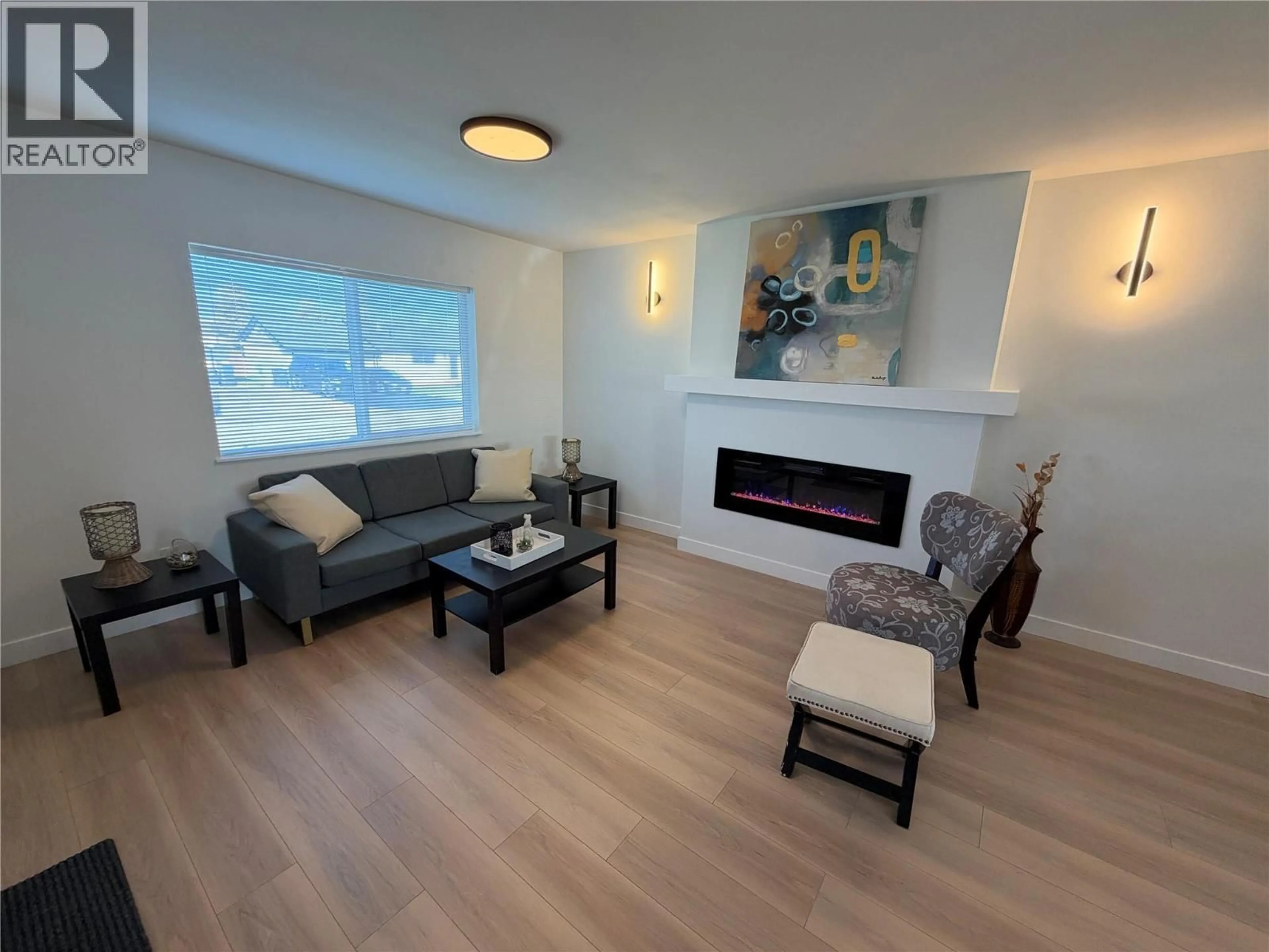 Living room with furniture, wood/laminate floor for 1217 114 AVENUE, Dawson Creek British Columbia V1G3A6