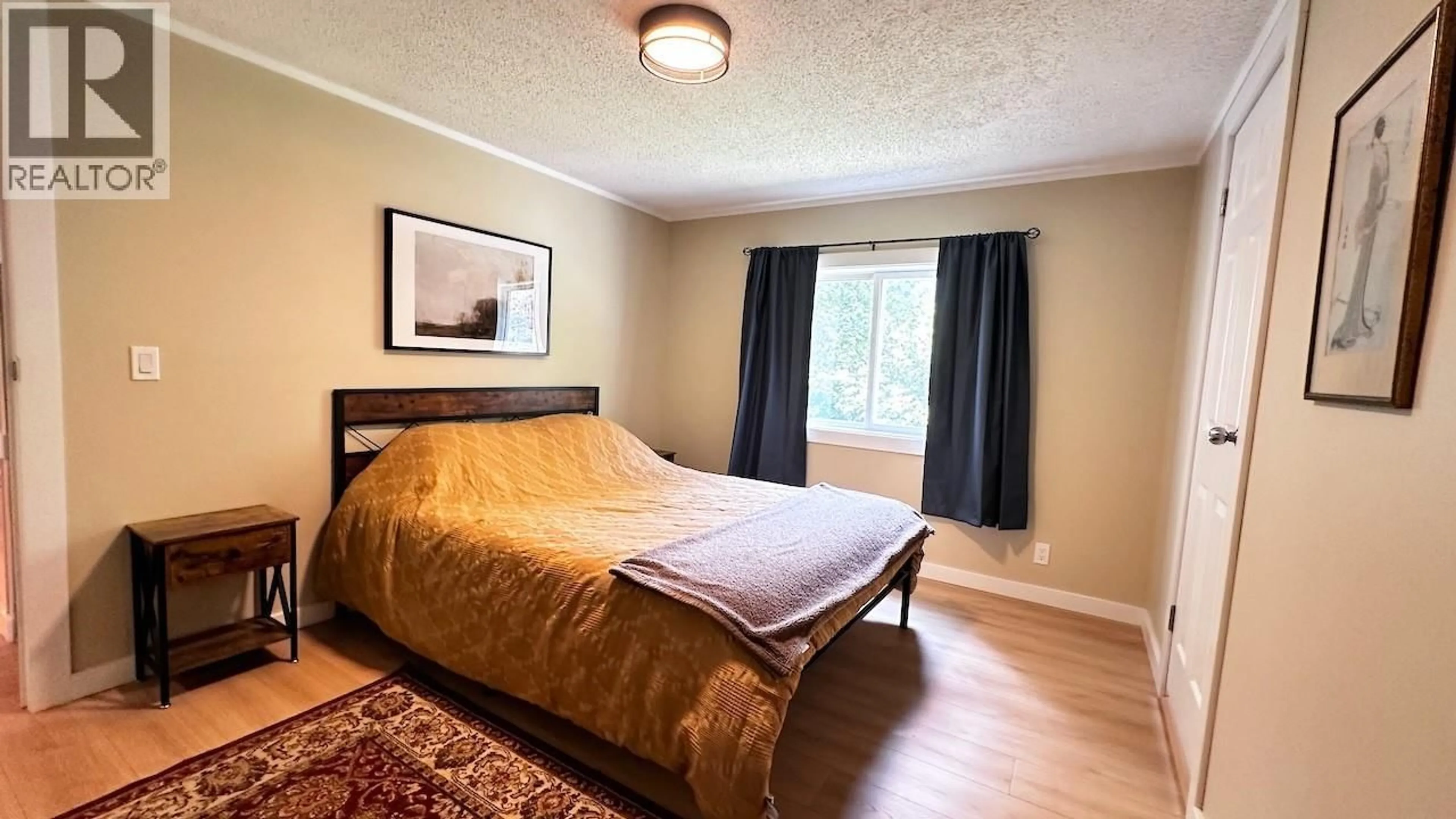 Bedroom with bed, wood/laminate floor for 811 VICTORIA STREET, New Denver British Columbia V0G1S0