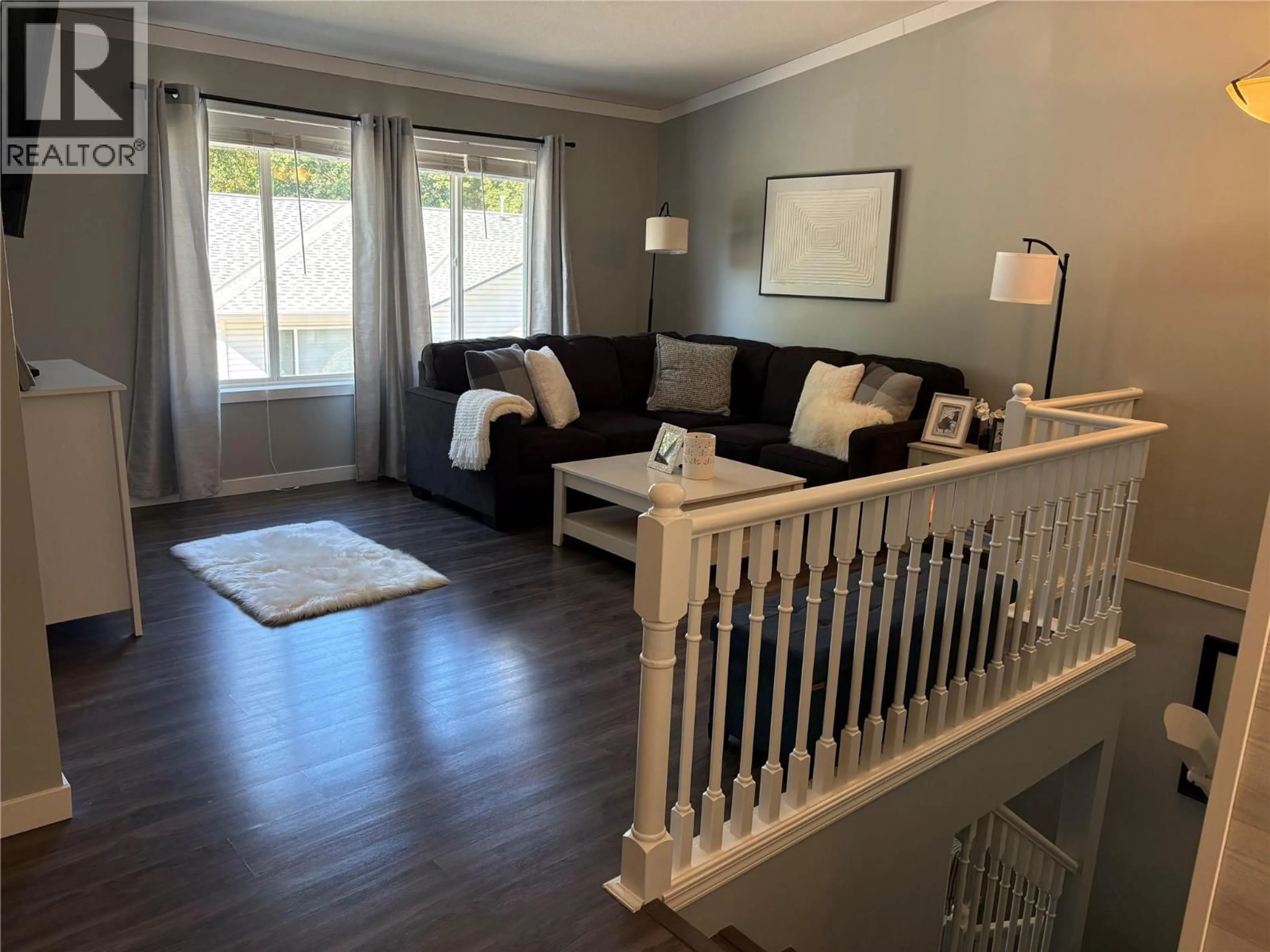 Living room with furniture, wood/laminate floor for 111 - 1801 53 AVENUE, Vernon British Columbia V1T4E7