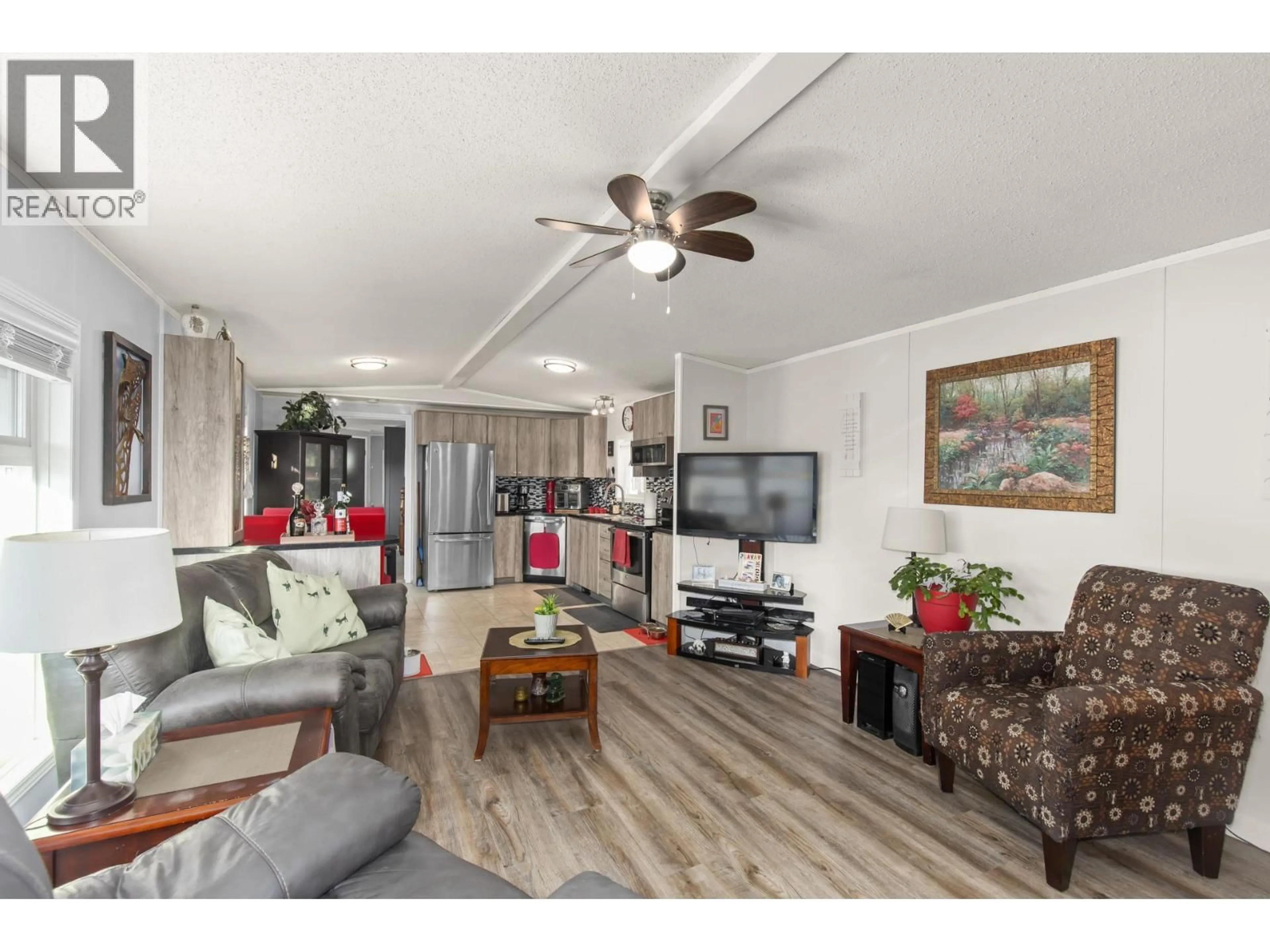 Living room with furniture, wood/laminate floor for 15A - 3270 SHANNON LAKE ROAD, West Kelowna British Columbia V4T2N2