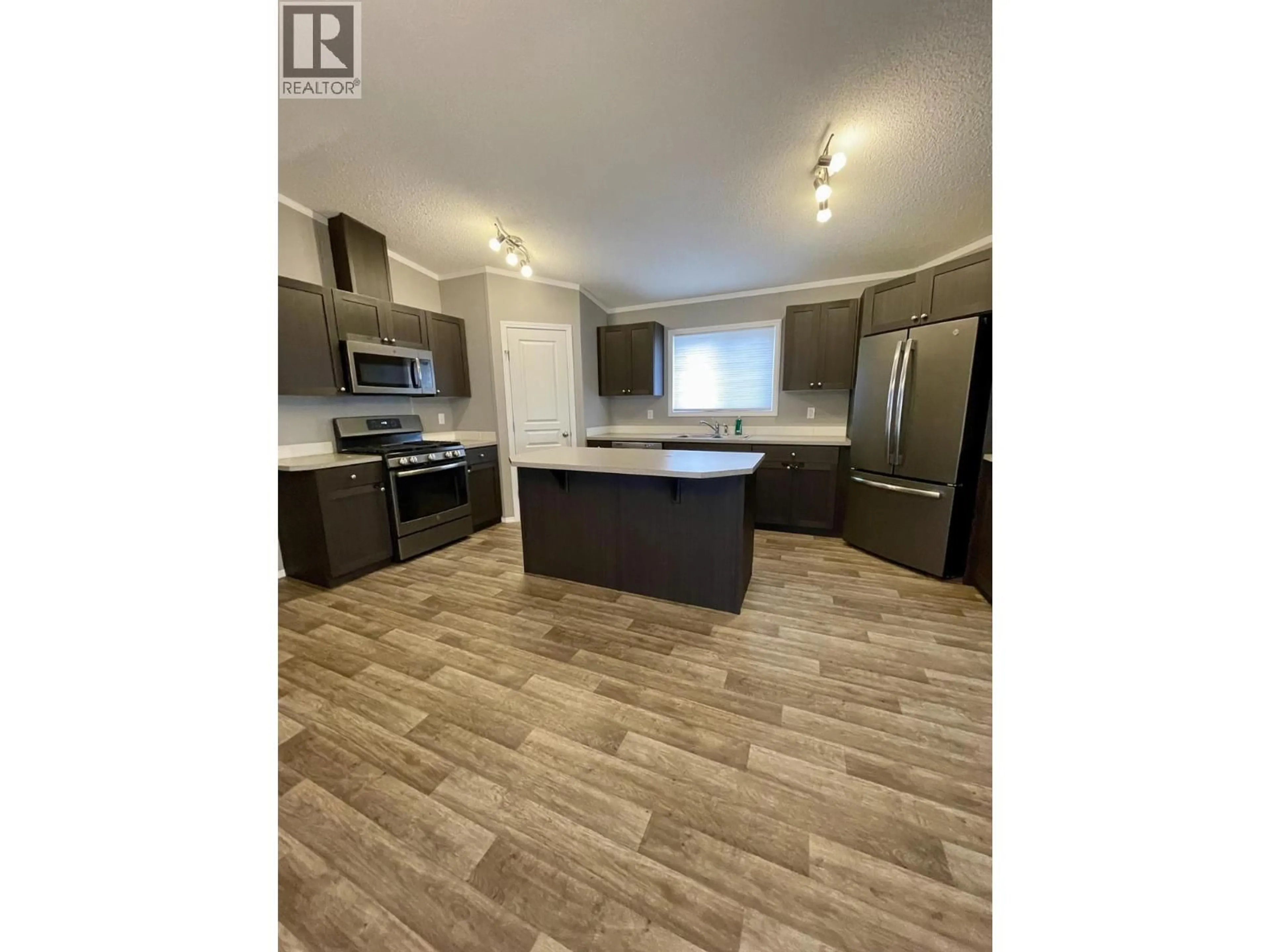Open concept kitchen, wood/laminate floor for 116 - 100 ASPEN DRIVE, Sparwood British Columbia V0B2G0