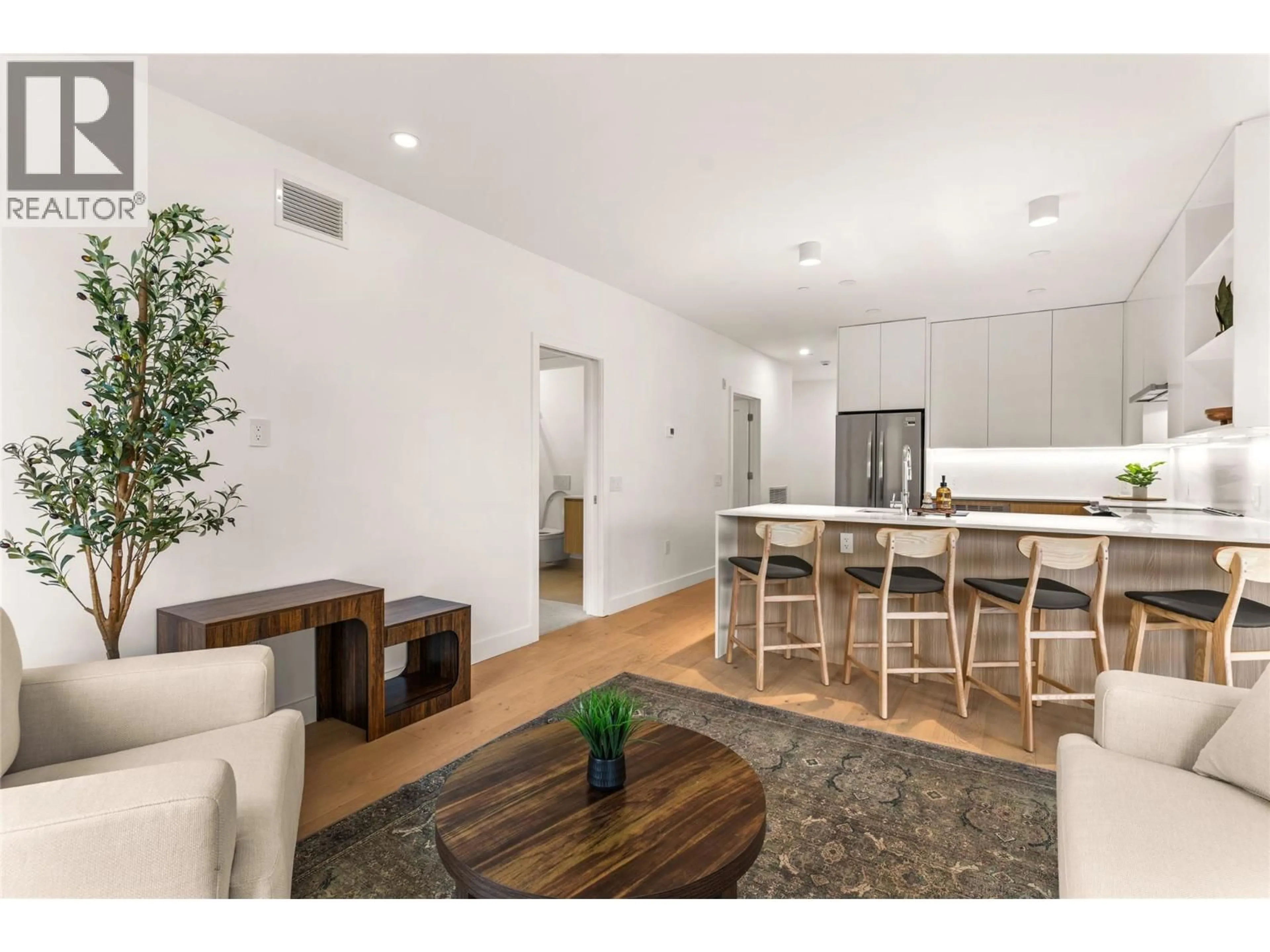 Open concept kitchen, wood/laminate floor for 2101 - 1702 COURSIER AVENUE, Revelstoke British Columbia V0E2S1