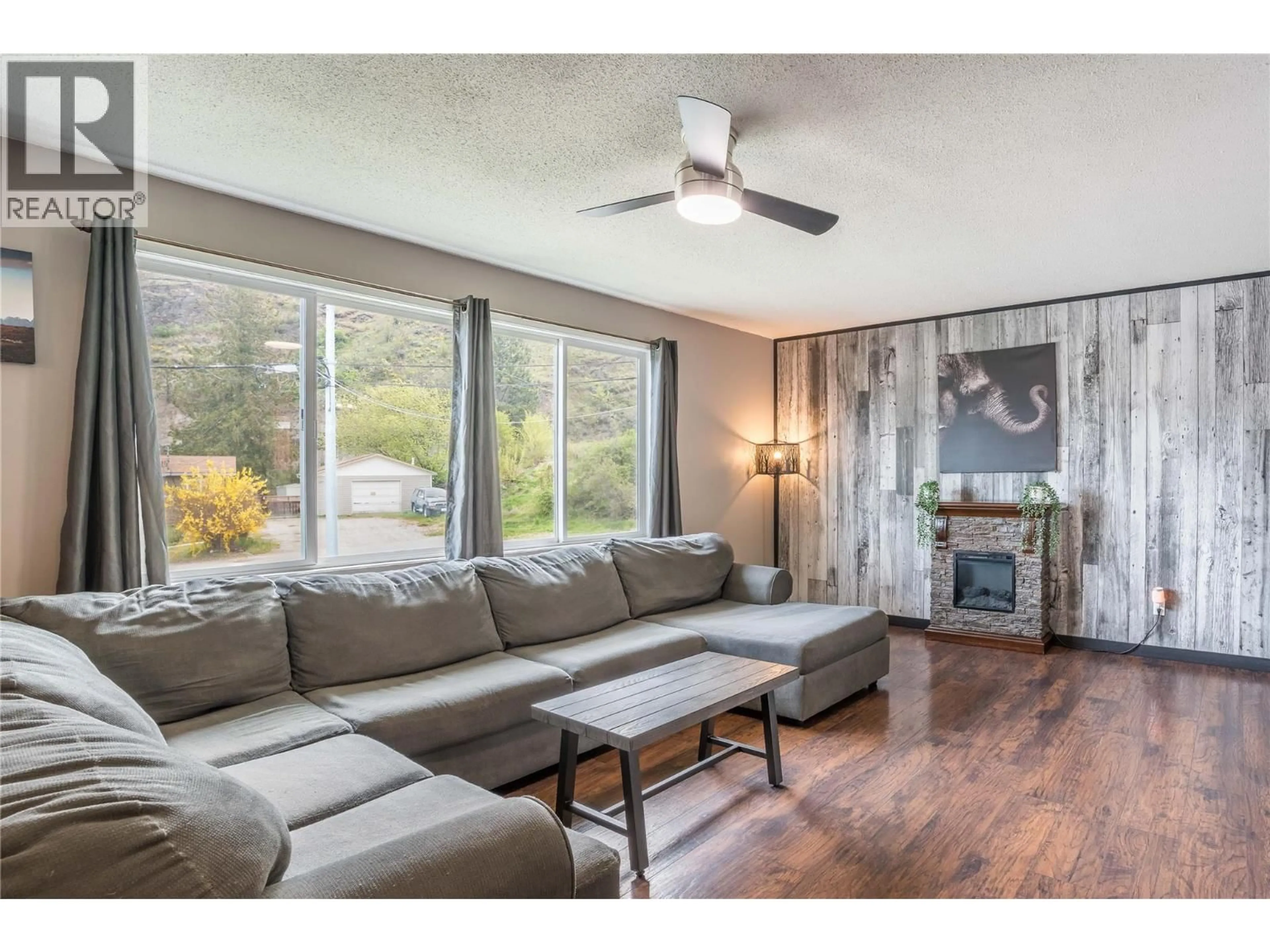 Living room with furniture, wood/laminate floor for 12408 CAMPBELL CRESCENT, Summerland British Columbia V0H1Z0