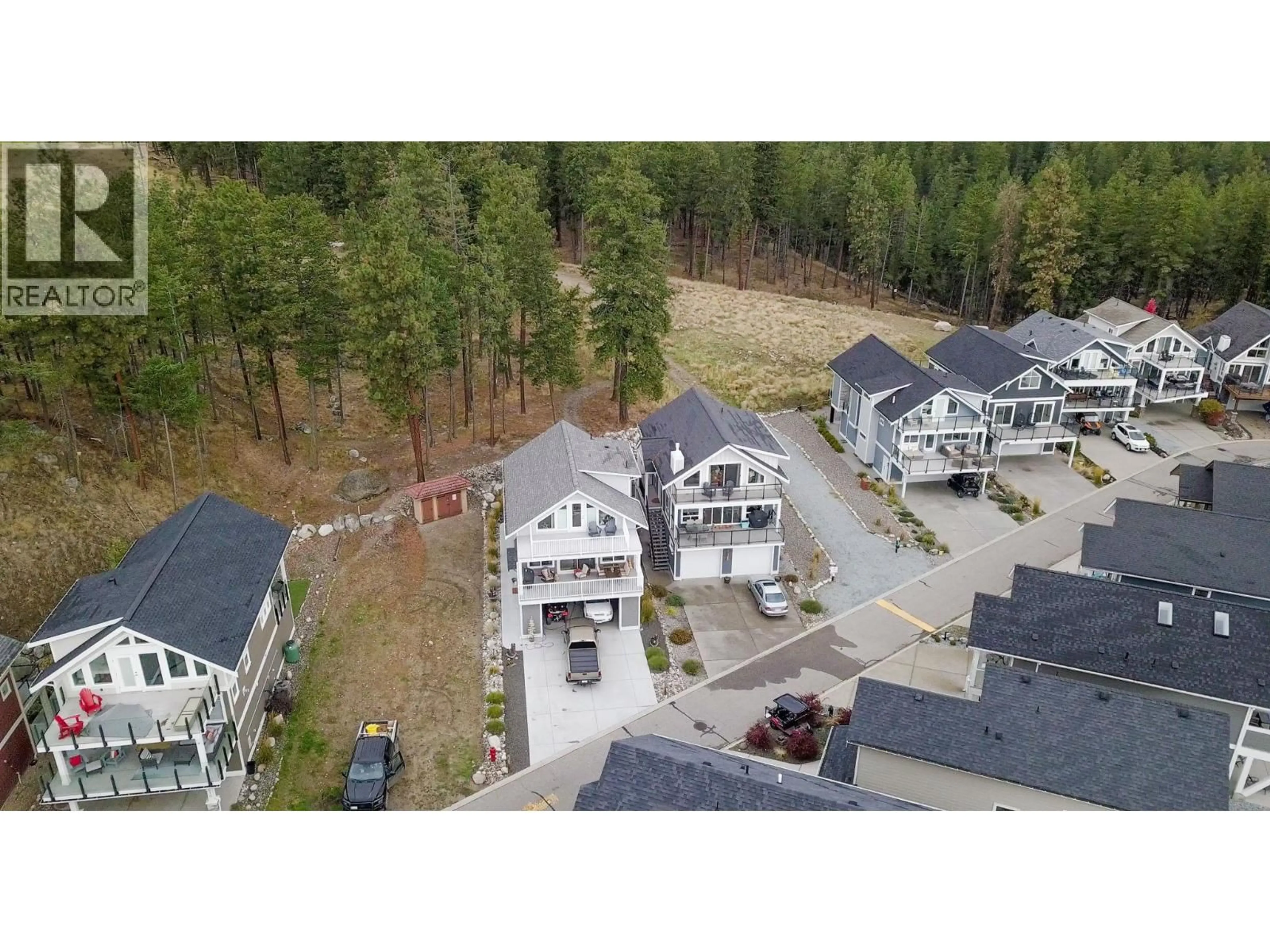 A pic from outside/outdoor area/front of a property/back of a property/a pic from drone, forest/trees view for 6976 TERAZONA DRIVE, Kelowna British Columbia V1Z3R8