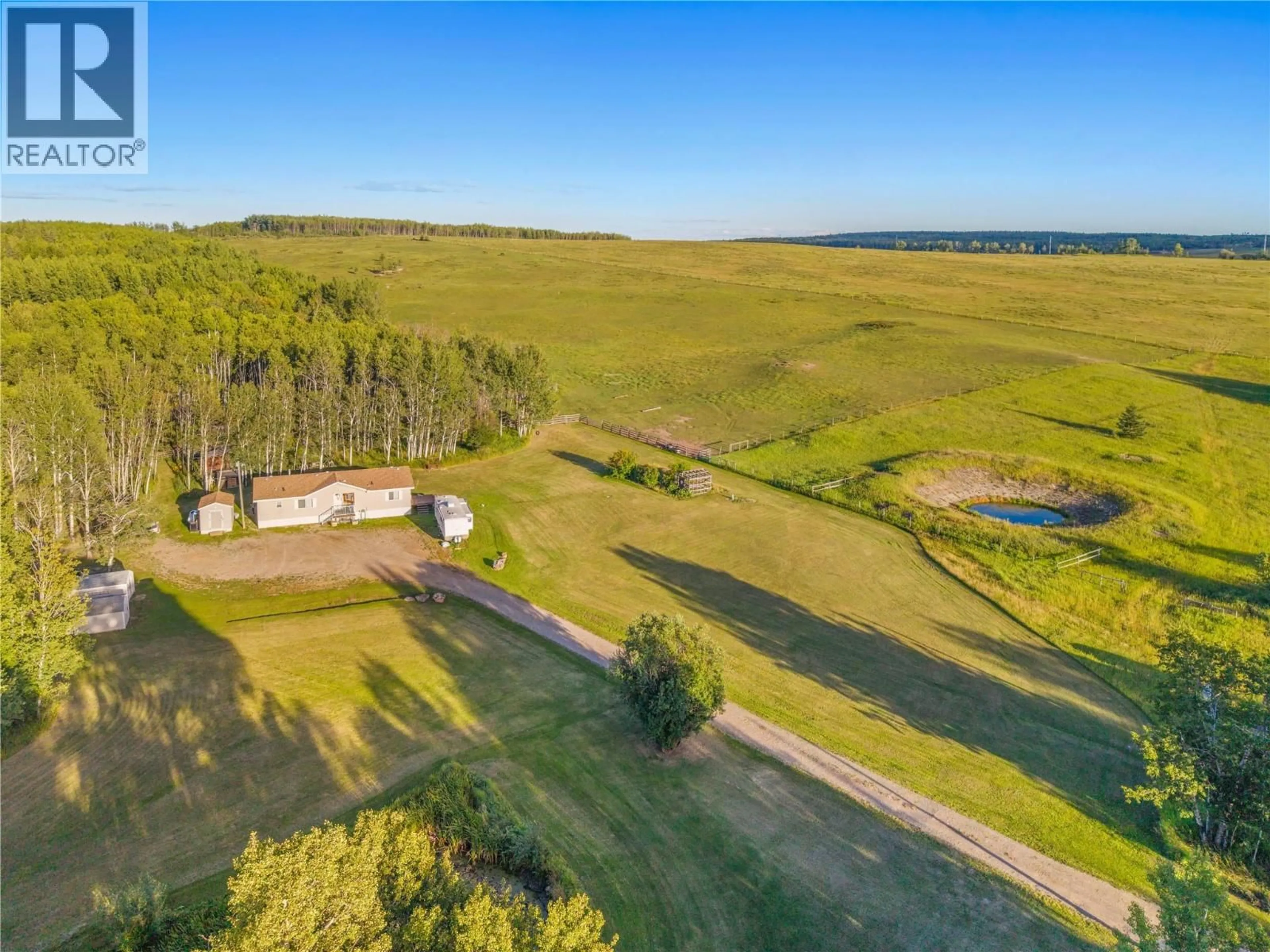 A pic from outside/outdoor area/front of a property/back of a property/a pic from drone, water/lake/river/ocean view for 9666 251 ROAD, Dawson Creek British Columbia V1G0J2