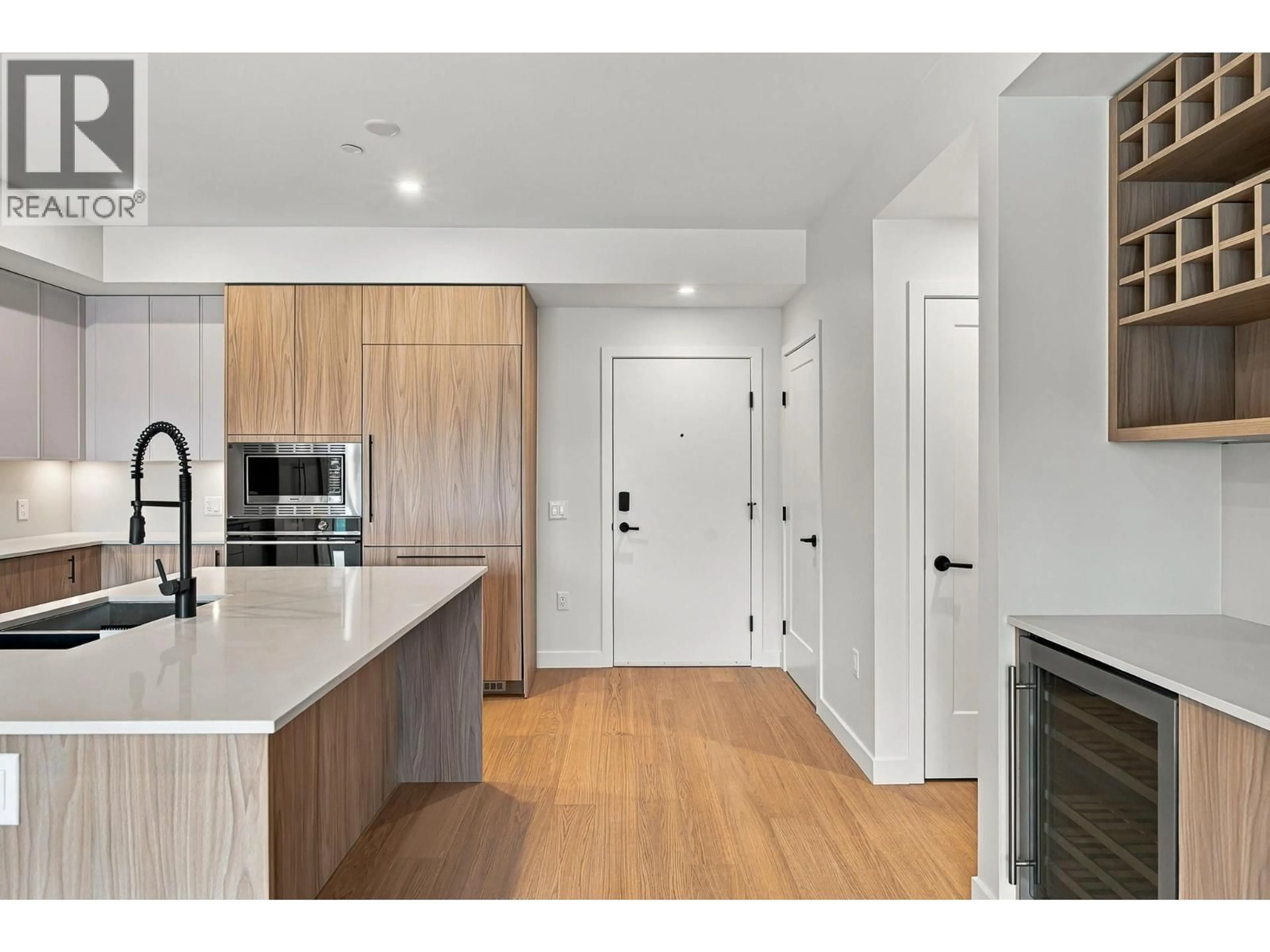 Open concept kitchen, wood/laminate floor for 306 - 9654 BENCHLAND DRIVE, Lake Country British Columbia V4V0A4
