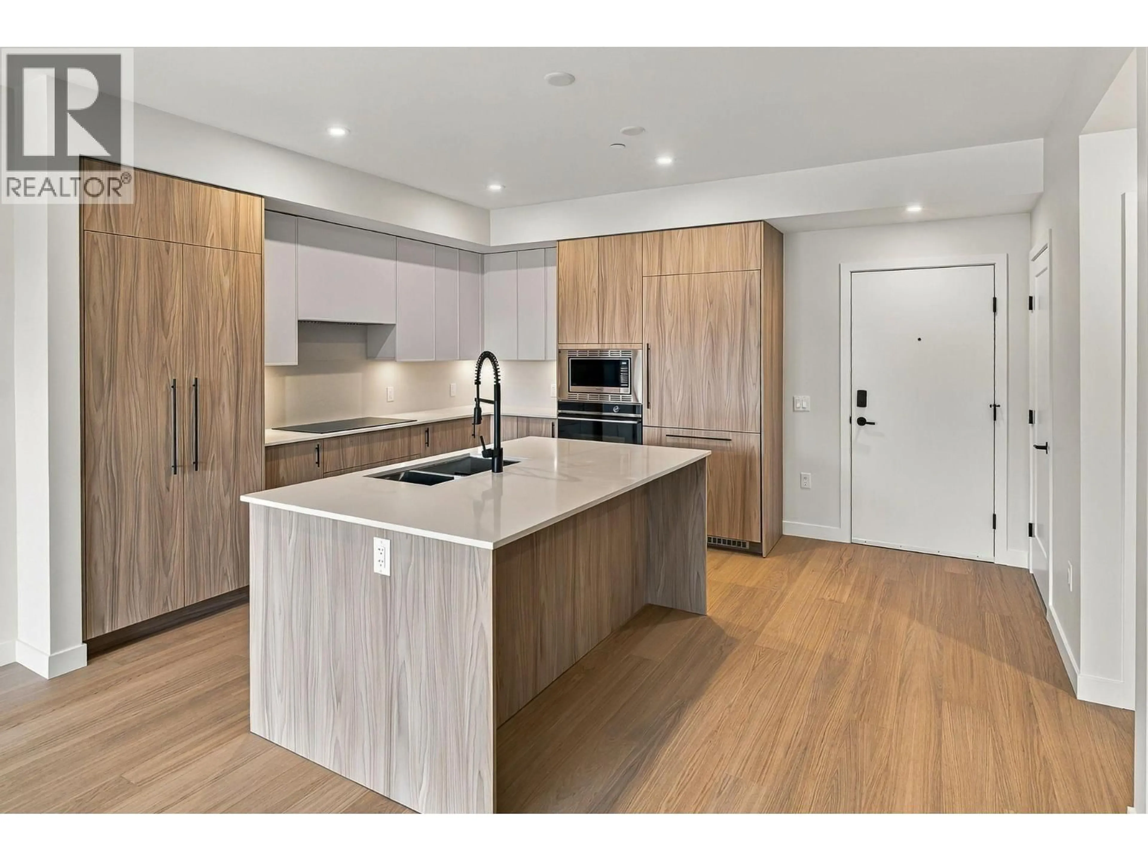 Open concept kitchen, wood/laminate floor for 306 - 9654 BENCHLAND DRIVE, Lake Country British Columbia V4V0A4