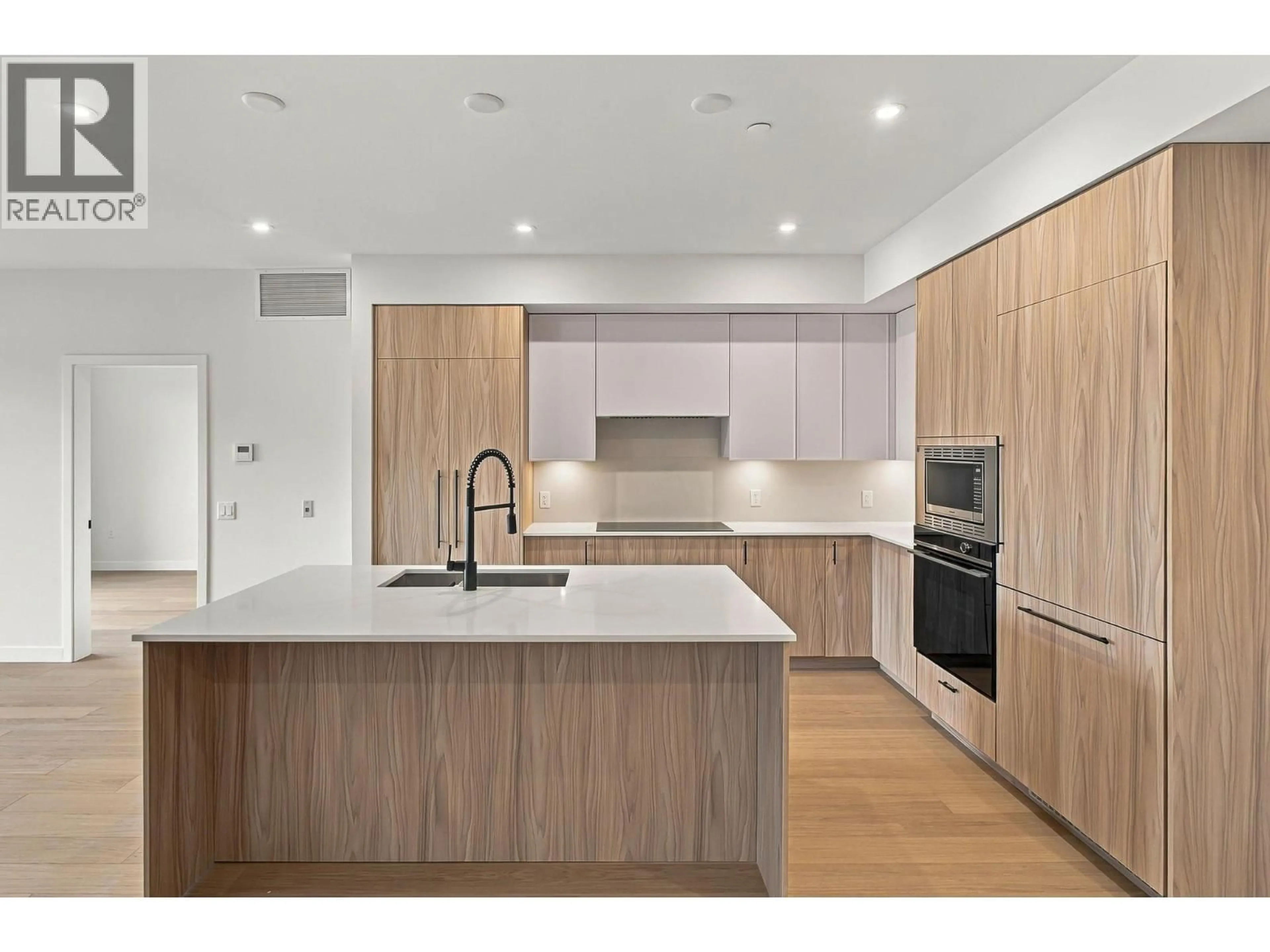 Open concept kitchen, wood/laminate floor for 306 - 9654 BENCHLAND DRIVE, Lake Country British Columbia V4V0A4