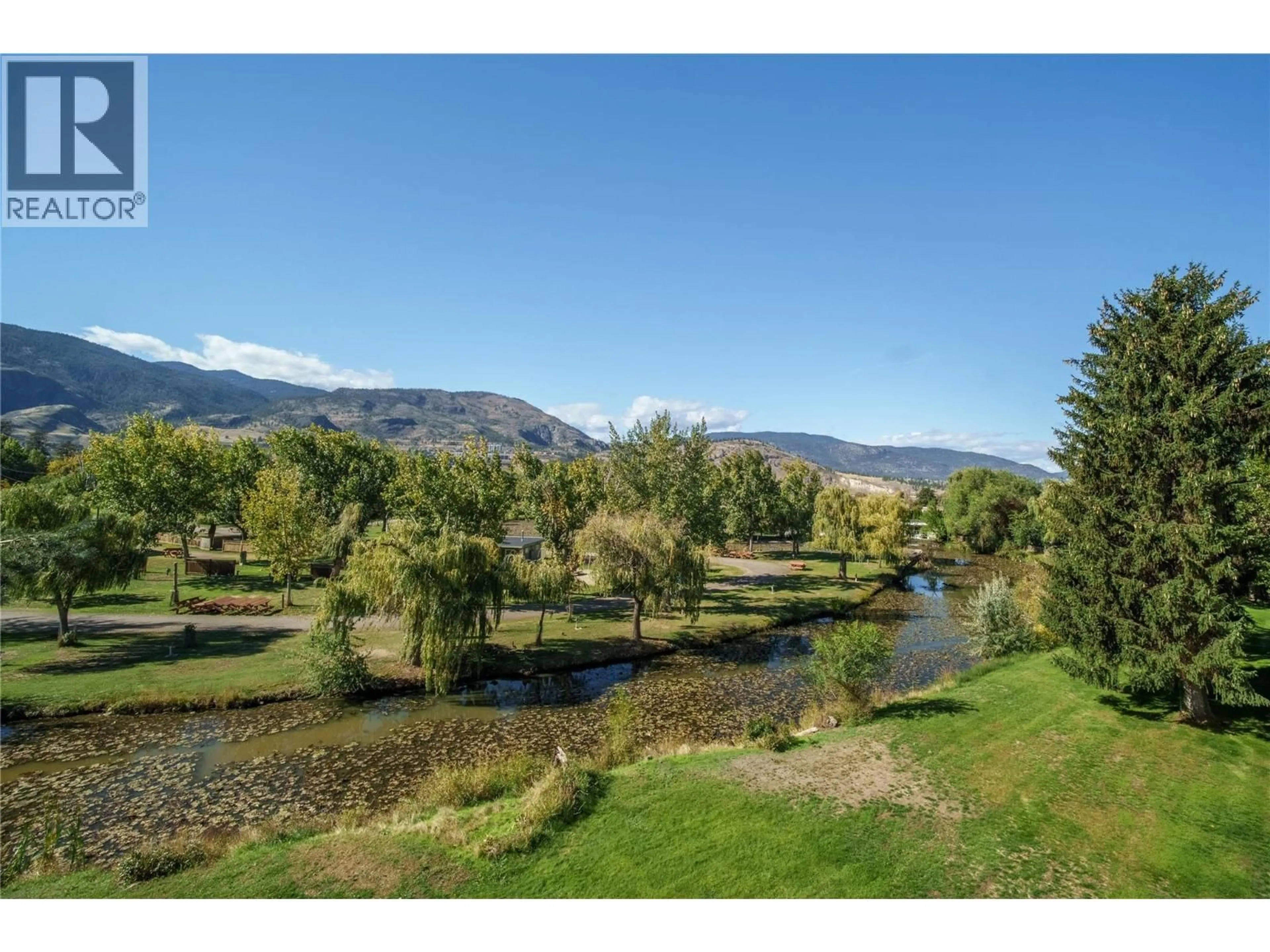 A pic from outside/outdoor area/front of a property/back of a property/a pic from drone, water/lake/river/ocean view for 413 - 150 SKAHA PLACE, Penticton British Columbia V2A7K1