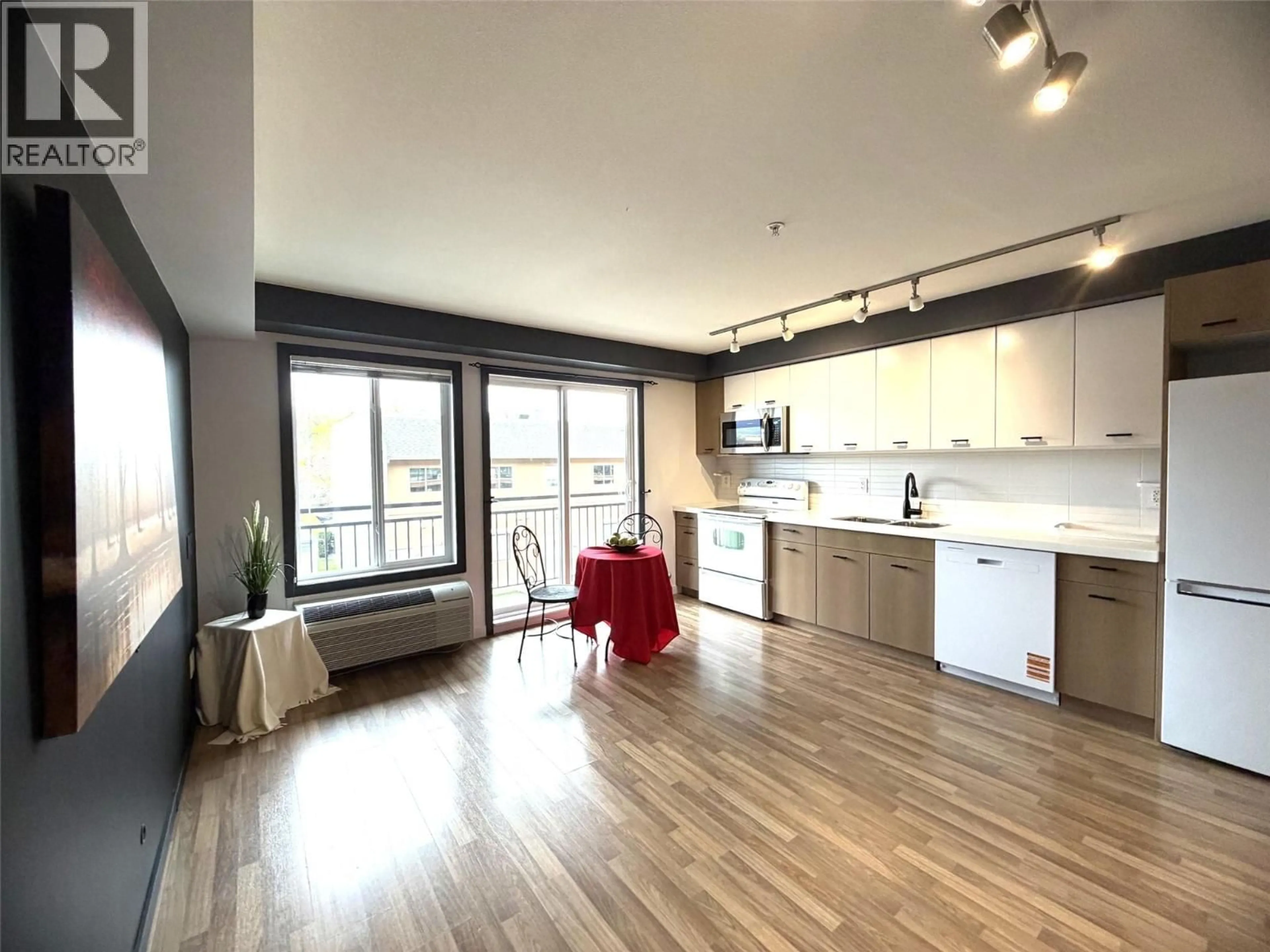 Open concept kitchen, wood/laminate floor for 218 - 1550 DICKSON AVENUE, Kelowna British Columbia V1Y1H7