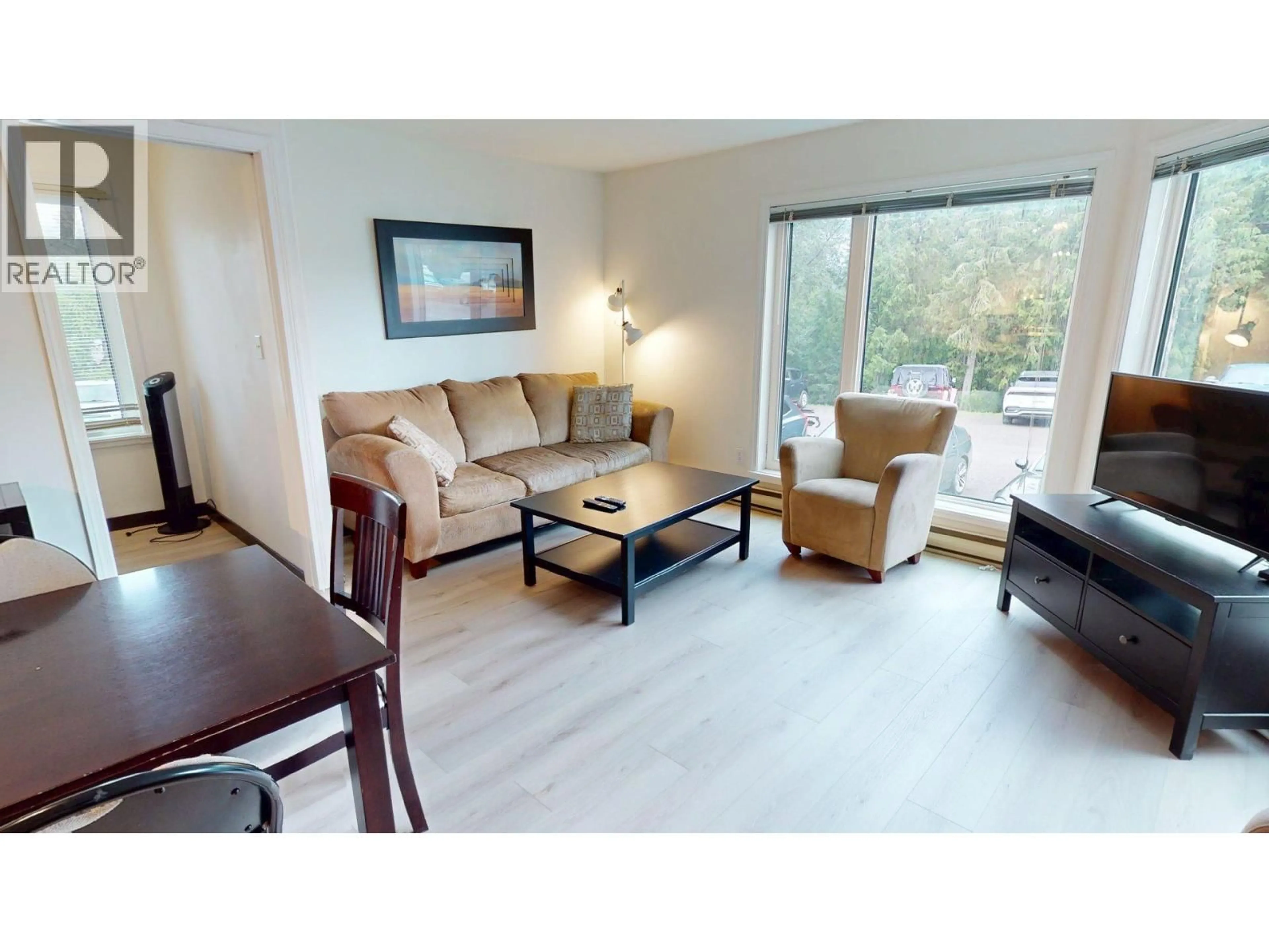 Living room with furniture, wood/laminate floor for 101-4559 TIMBERLINE CRESCENT, Fernie British Columbia V0B1M6