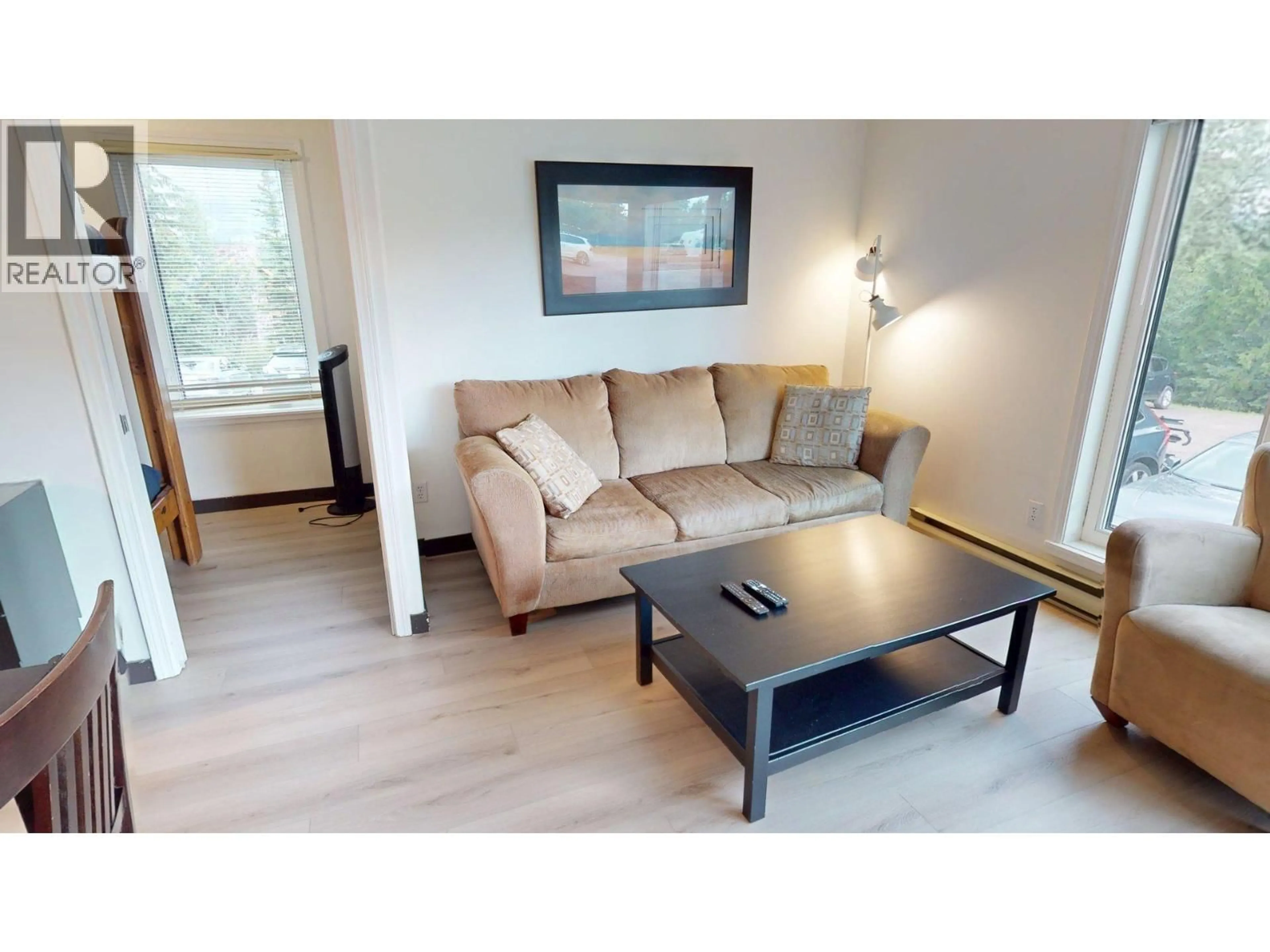 Living room with furniture, wood/laminate floor for 101-4559 TIMBERLINE CRESCENT, Fernie British Columbia V0B1M6