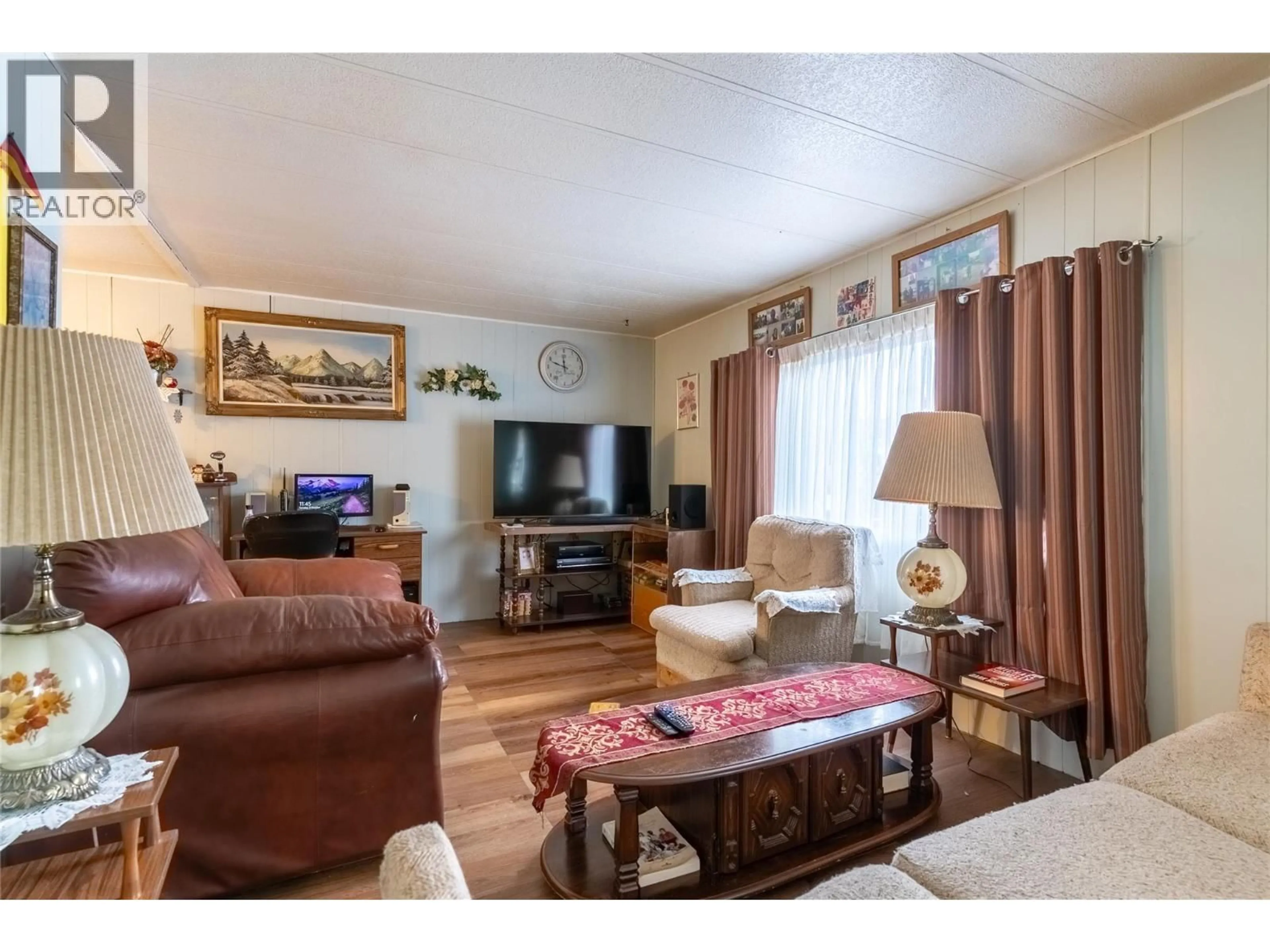 Living room with furniture, wood/laminate floor for 13 TOPAZ CRESCENT, Logan Lake British Columbia V0K1W0