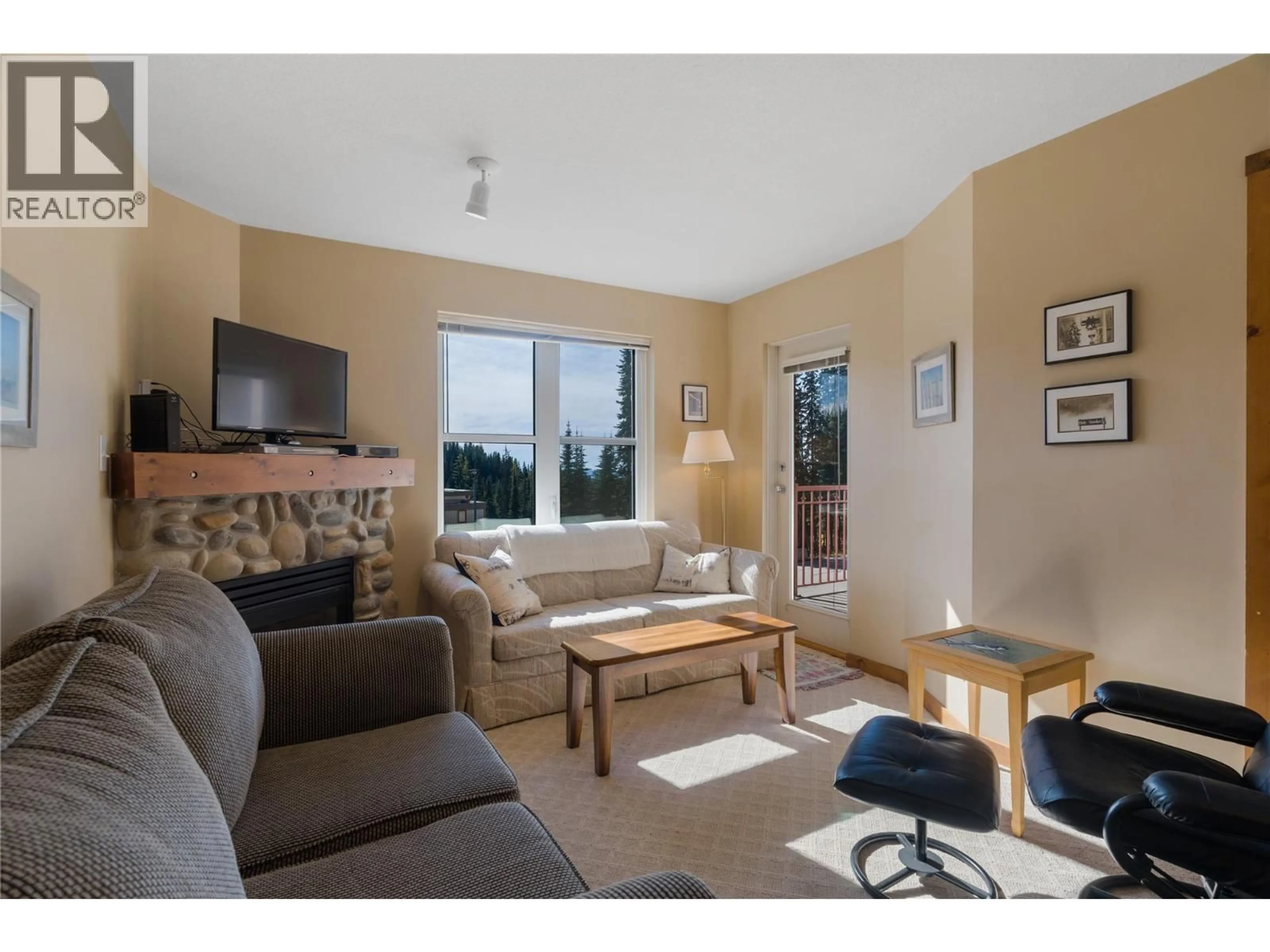 Living room with furniture, wood/laminate floor for 204 - 9802 SILVER STAR ROAD, Silver Star British Columbia V1B3W9