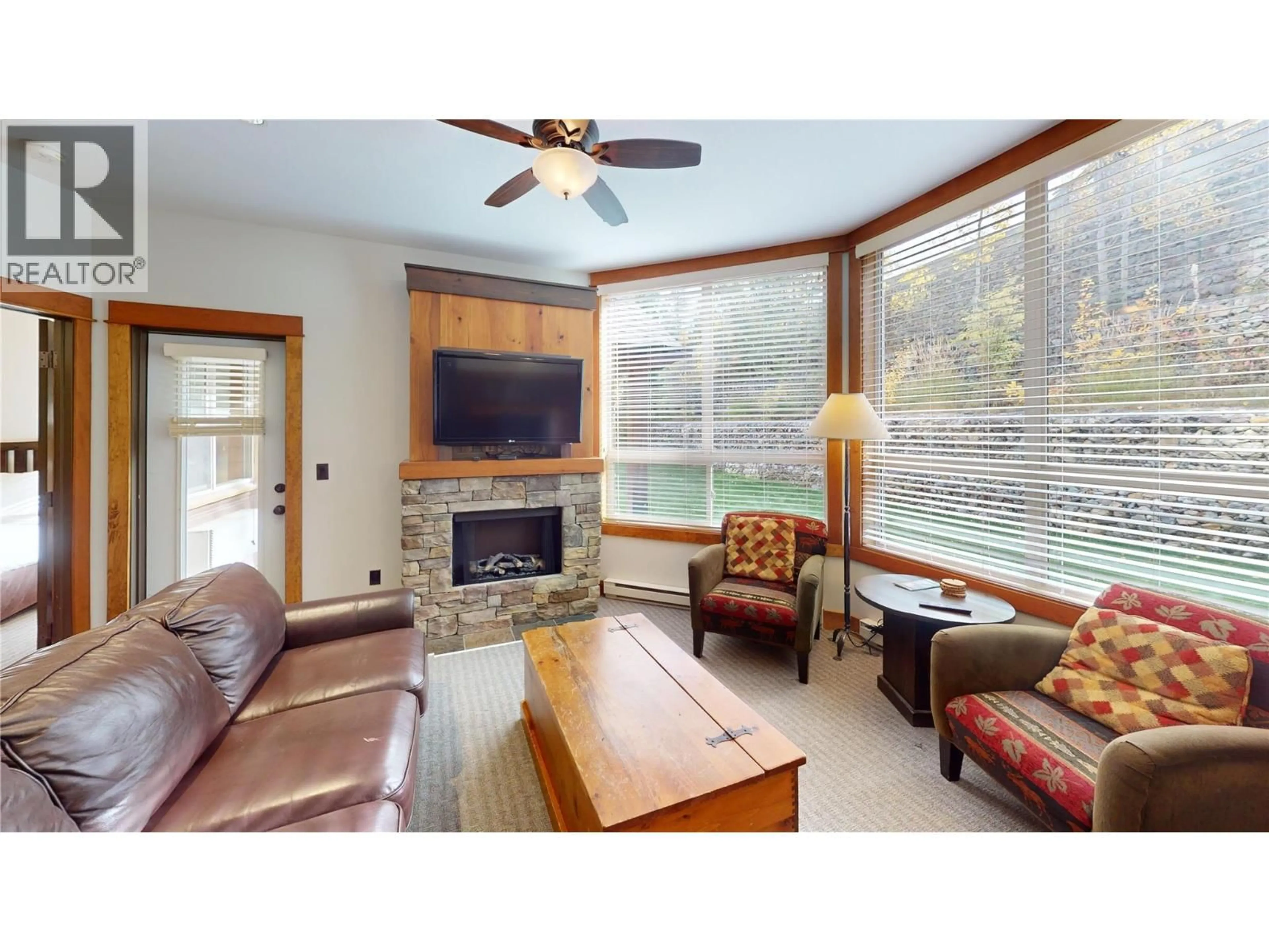 Living room with furniture, wood/laminate floor for 613B - 4559 TIMBERLINE CRESCENT, Fernie British Columbia V0B1M6