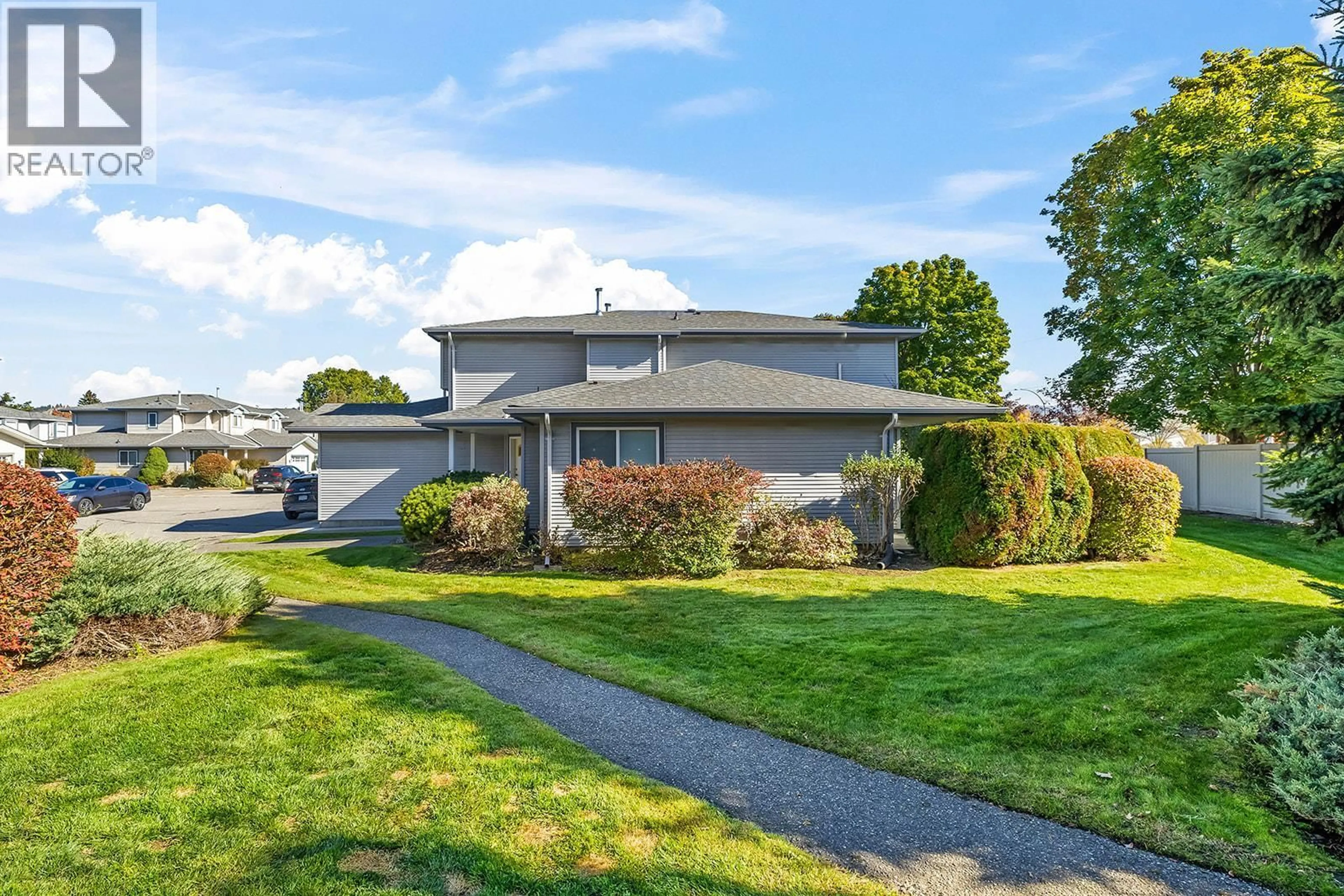 Home with vinyl exterior material, street for 8 - 1120 GUISACHAN ROAD, Kelowna British Columbia V1Y9R5