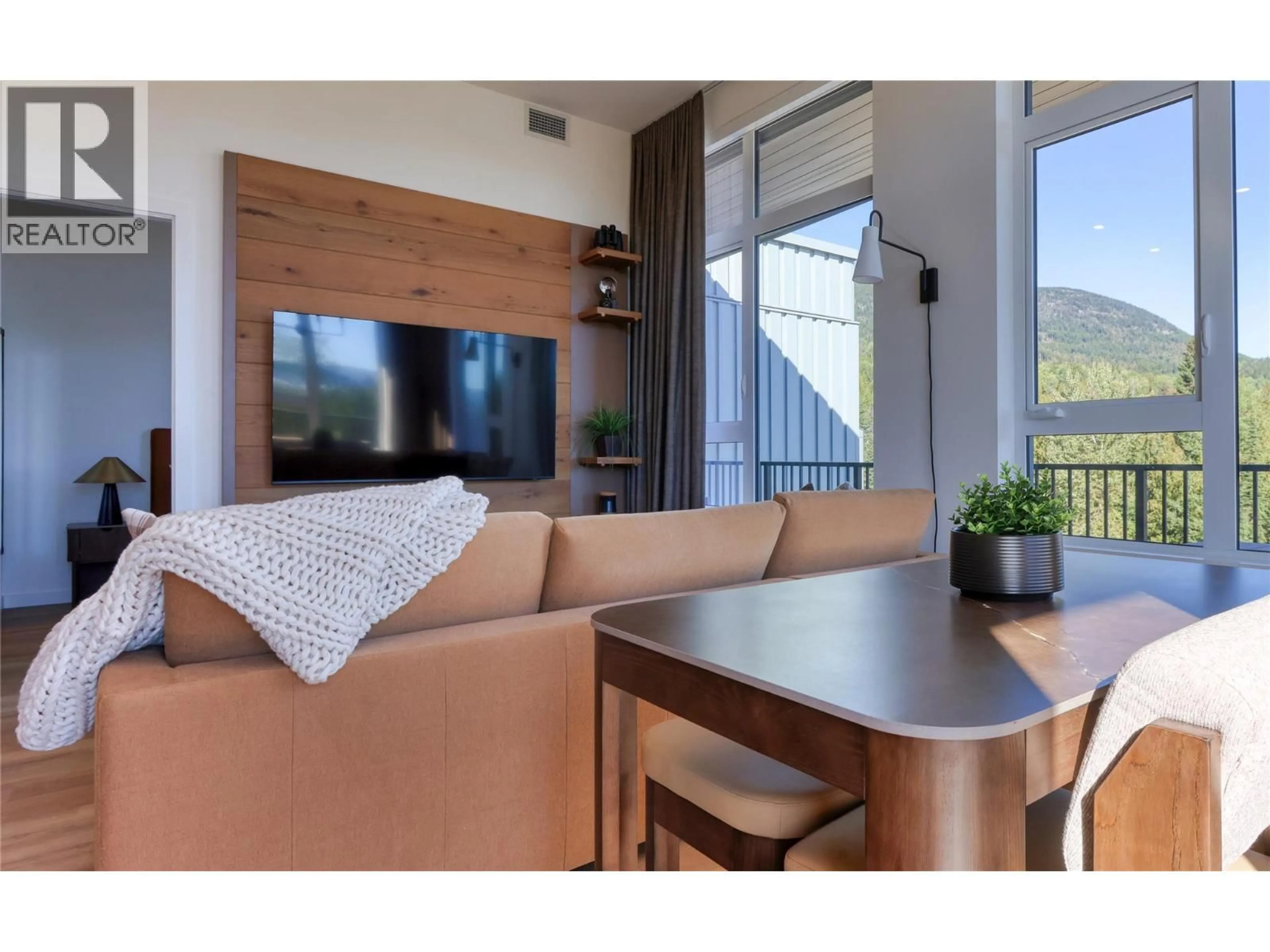 Living room with furniture, wood/laminate floor for 216 - 4240 RED MOUNTAIN ROAD, Rossland British Columbia V0G1Y0