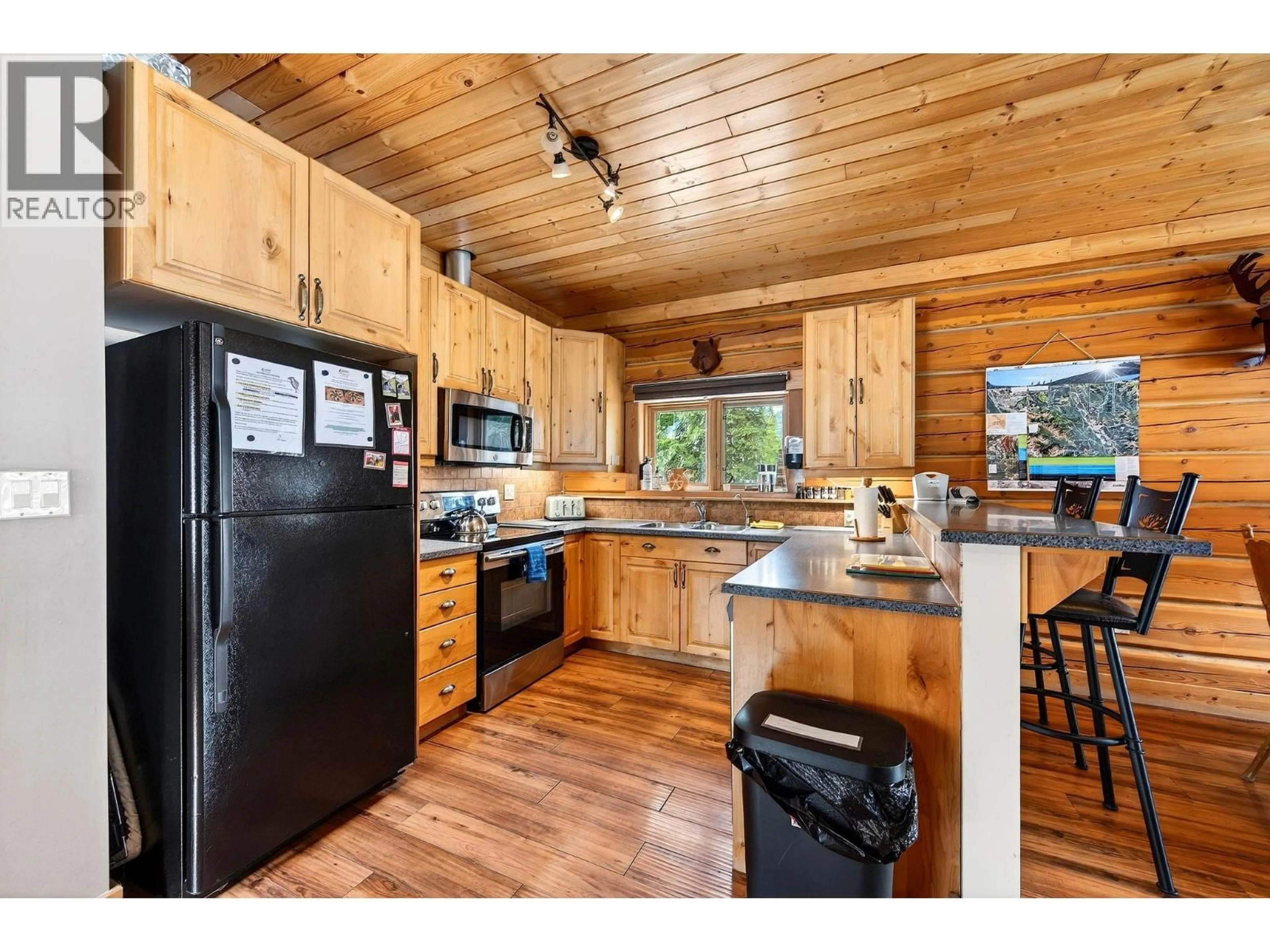 Open concept kitchen, wood/laminate floor for B-1732 OBERG JOHNSON ROAD, Golden British Columbia V0A1H1