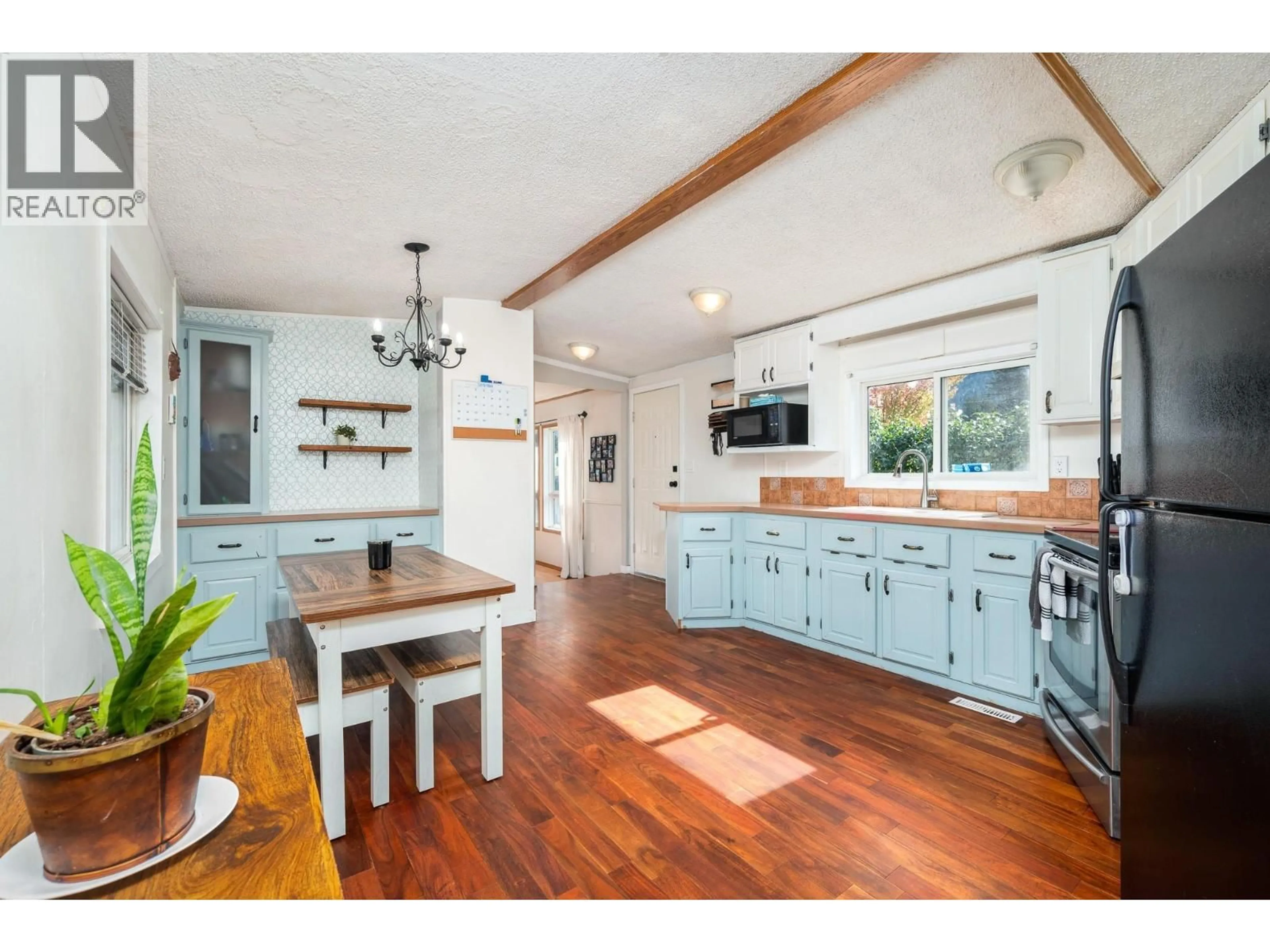Open concept kitchen, wood/laminate floor for 5846 JEN SHERRI PLACE, Falkland British Columbia V0E1W0