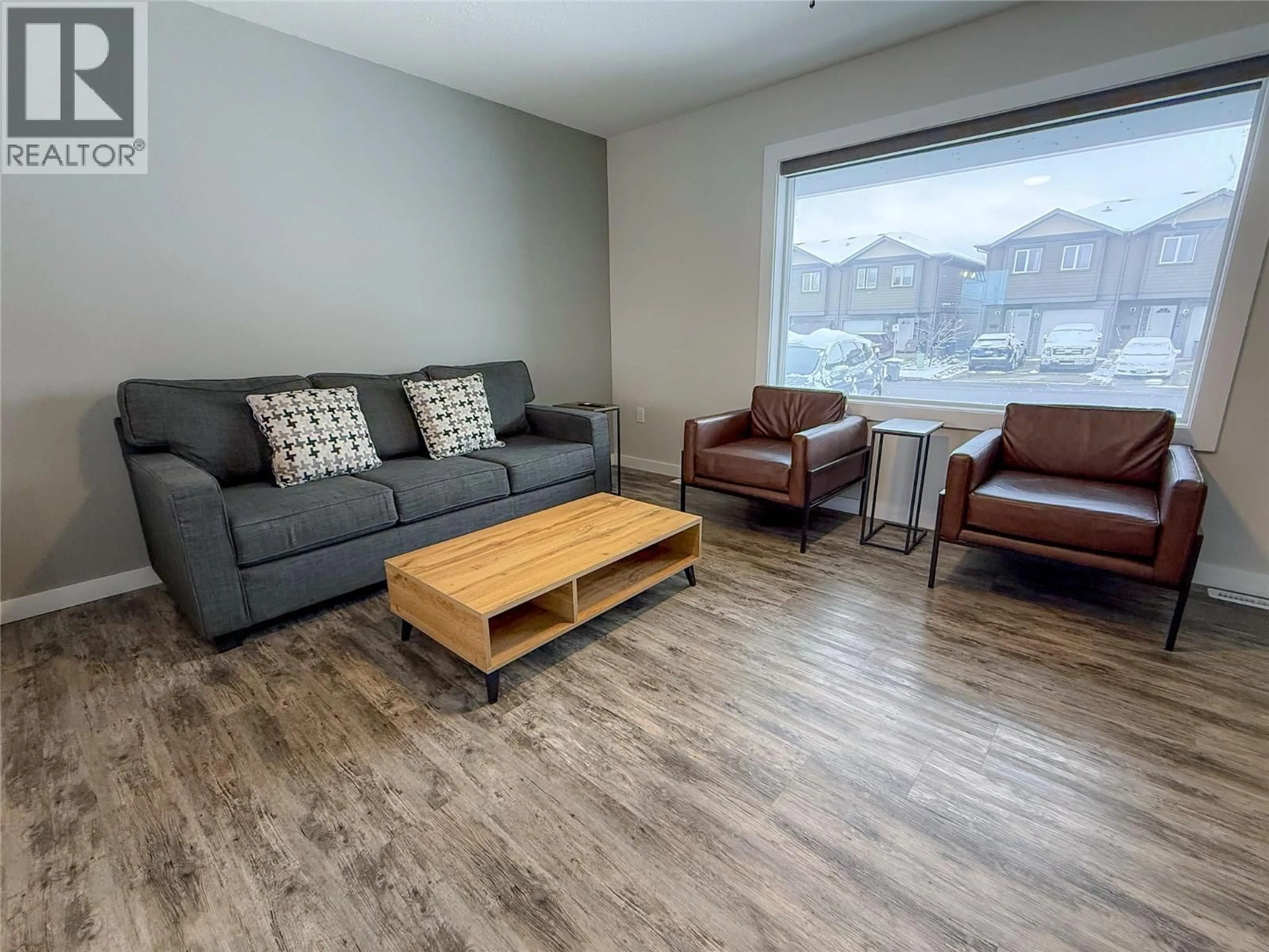 Living room with furniture, wood/laminate floor for LORAN DRIVE, Dawson Creek British Columbia V1G1B7