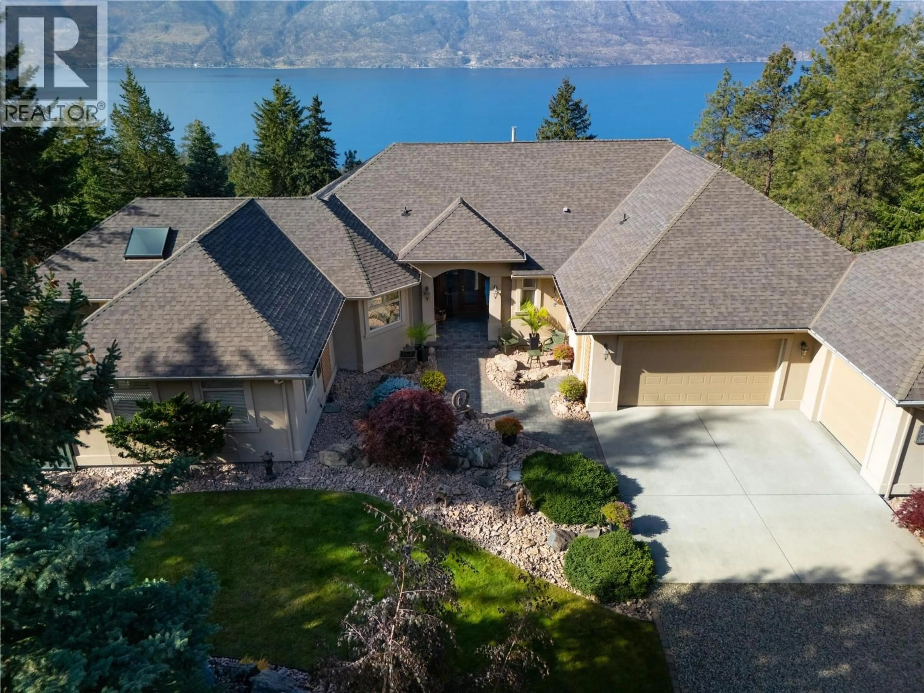 A pic from outside/outdoor area/front of a property/back of a property/a pic from drone, water/lake/river/ocean view for 5812 MCCOUBREY ROAD, Lake Country British Columbia V4V2L3