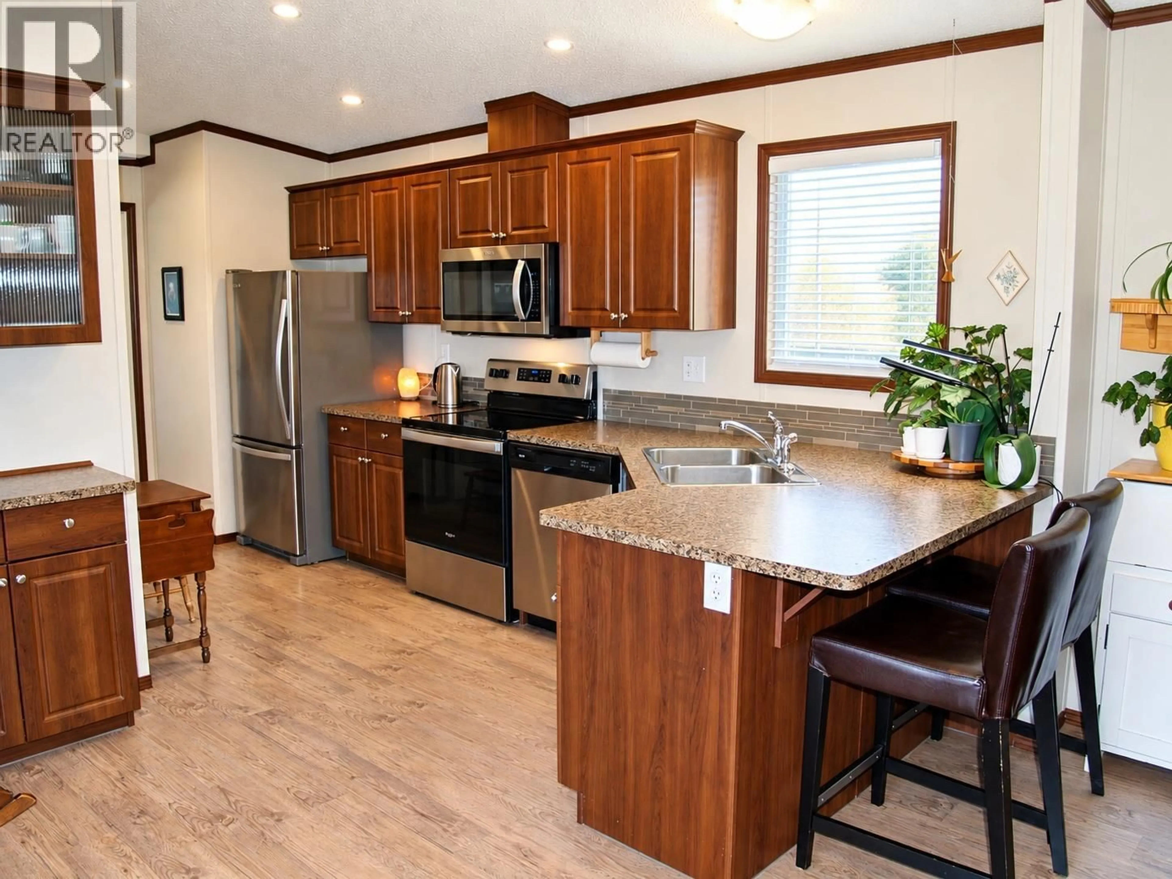 Open concept kitchen, wood/laminate floor for 110A - 3591 OLD VERNON ROAD, Kelowna British Columbia V1X6P4