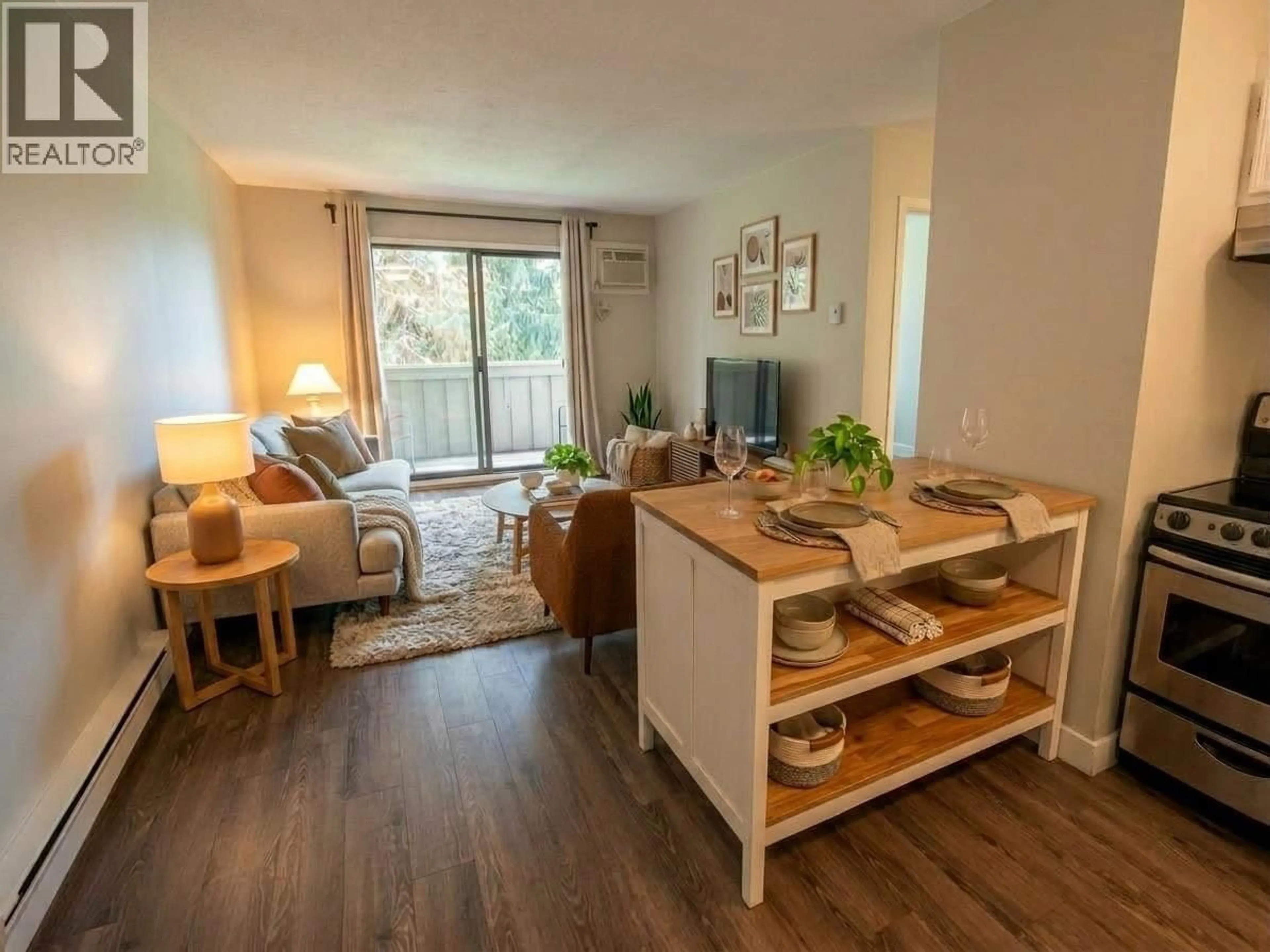 Living room with furniture, wood/laminate floor for 201 - 150 SKAHA PLACE, Penticton British Columbia V2A7K1