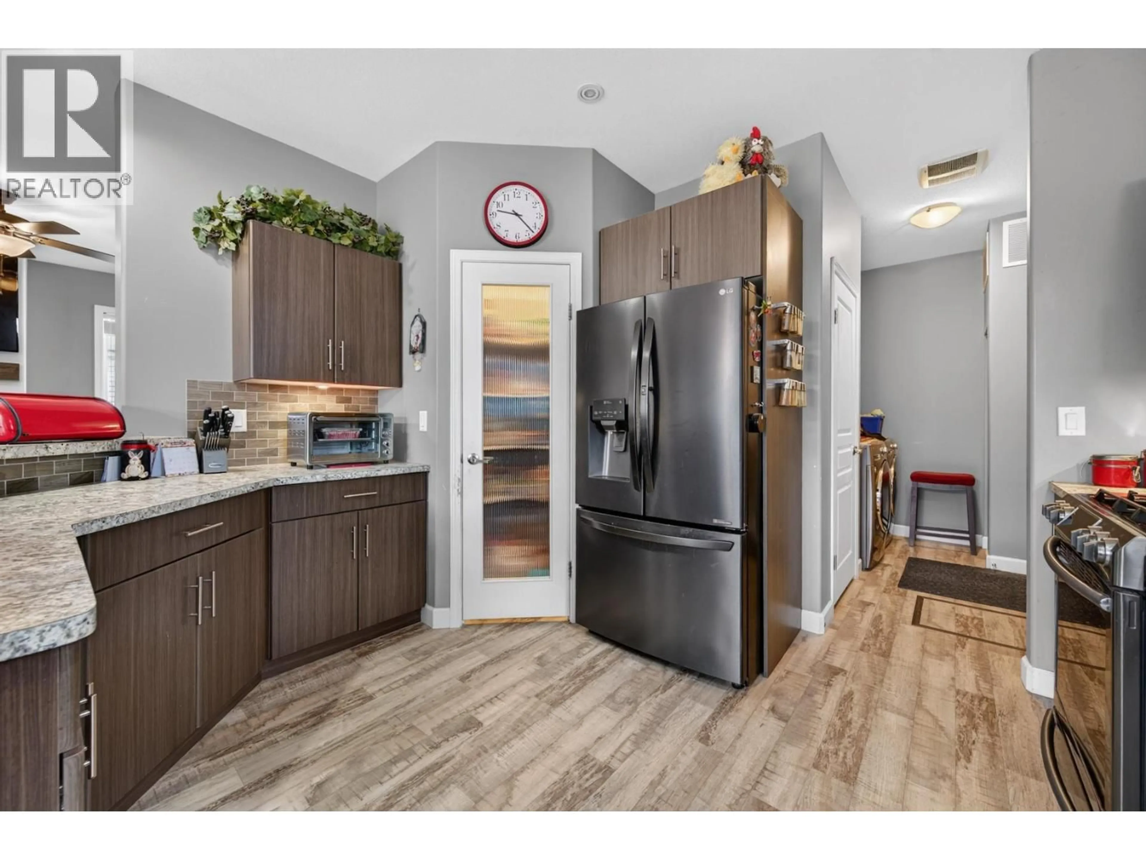 Open concept kitchen, wood/laminate floor for 1410 WALNUT AVENUE, Merritt British Columbia V1K1L3