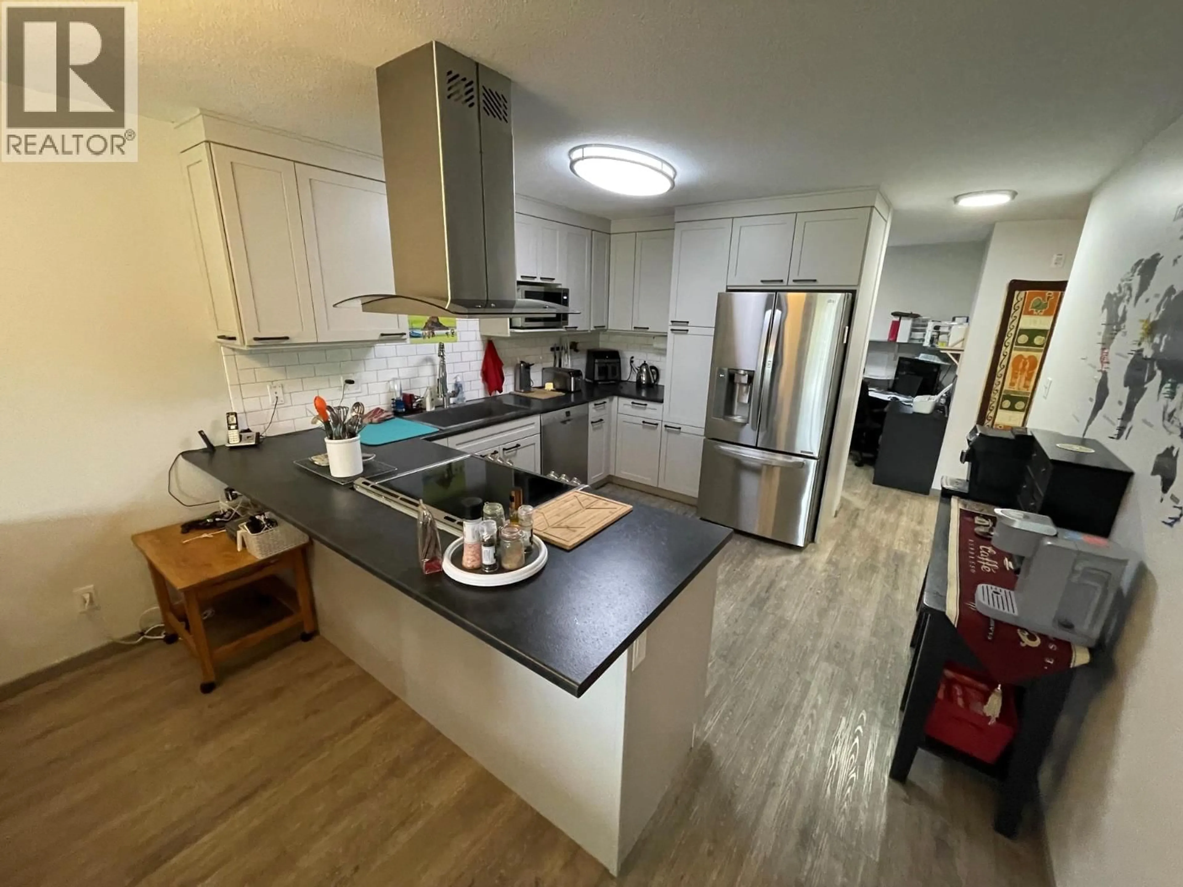 Open concept kitchen, wood/laminate floor for 105 - 7140 4TH STREET, Grand Forks British Columbia V0H1H0
