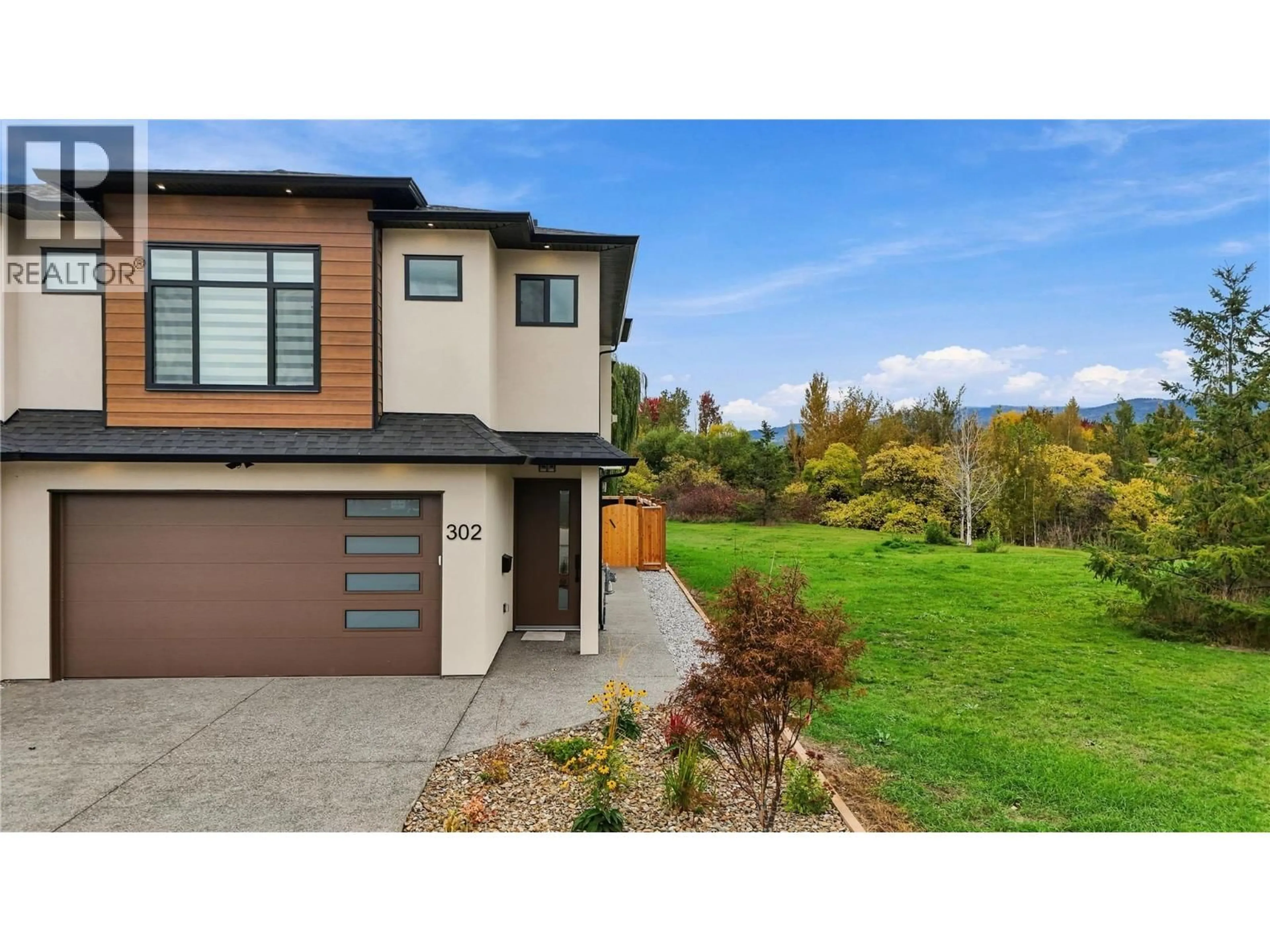 Home with brick exterior material, street for 302 SUMAC ROAD WEST, Kelowna British Columbia V1X6W8